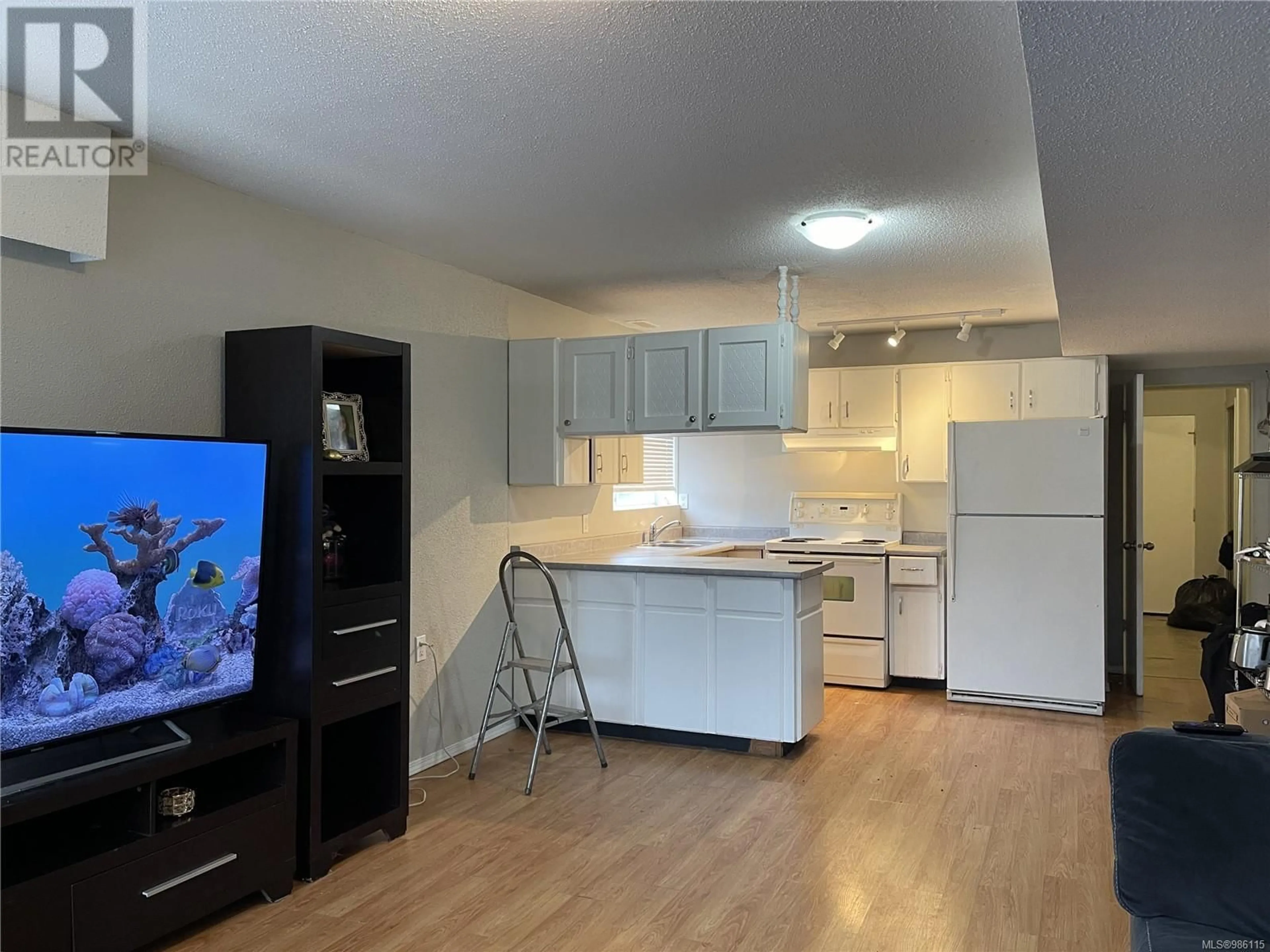 Open concept kitchen, wood/laminate floor for 4436 Redford St, Port Alberni British Columbia V9Y3R1