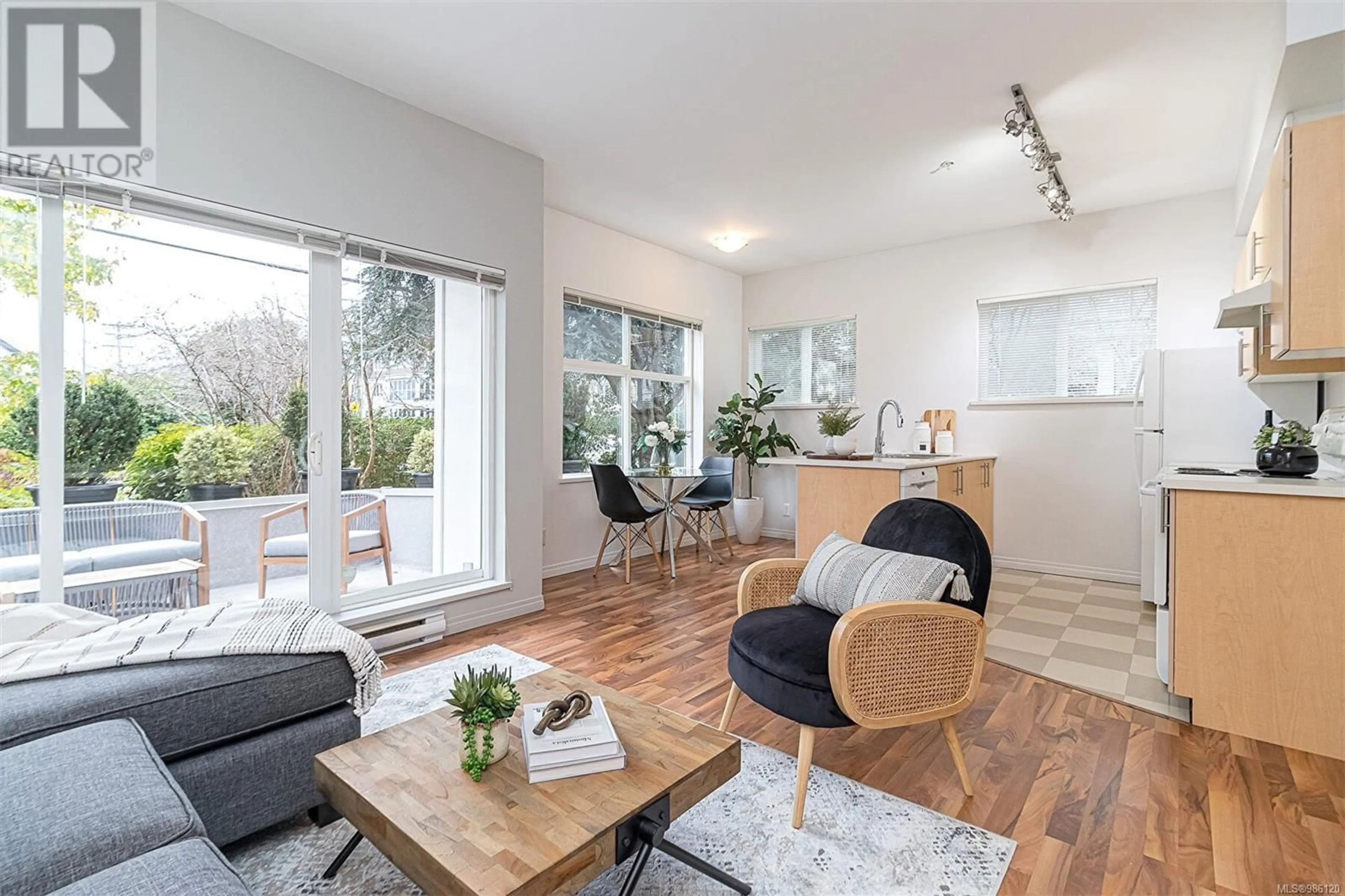 Living room with furniture, wood/laminate floor for 206 1550 Church Ave, Saanich British Columbia V8P2H1