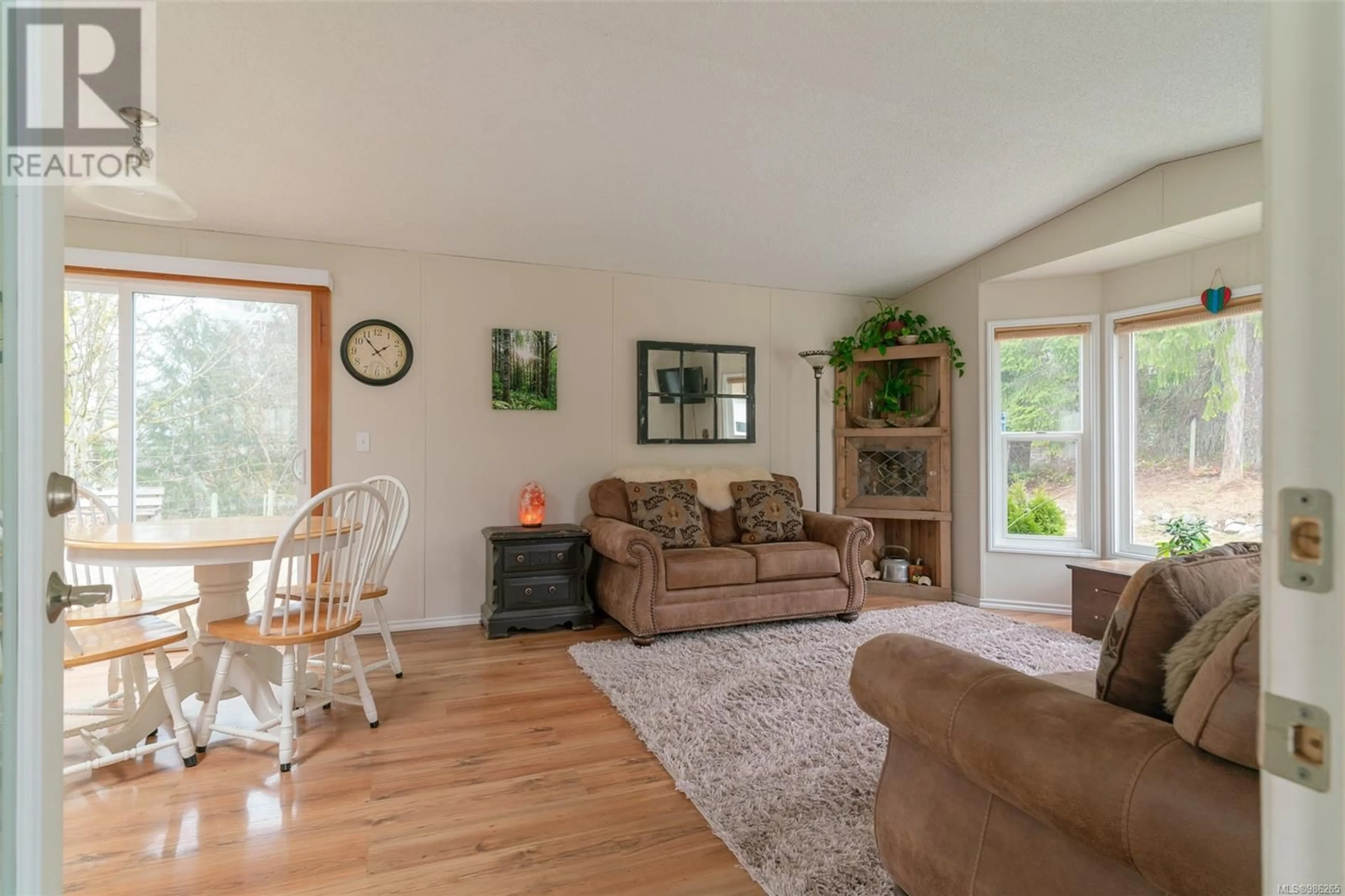 Living room with furniture, wood/laminate floor for 7100 Beaver Creek Rd, Port Alberni British Columbia V9Y8M3