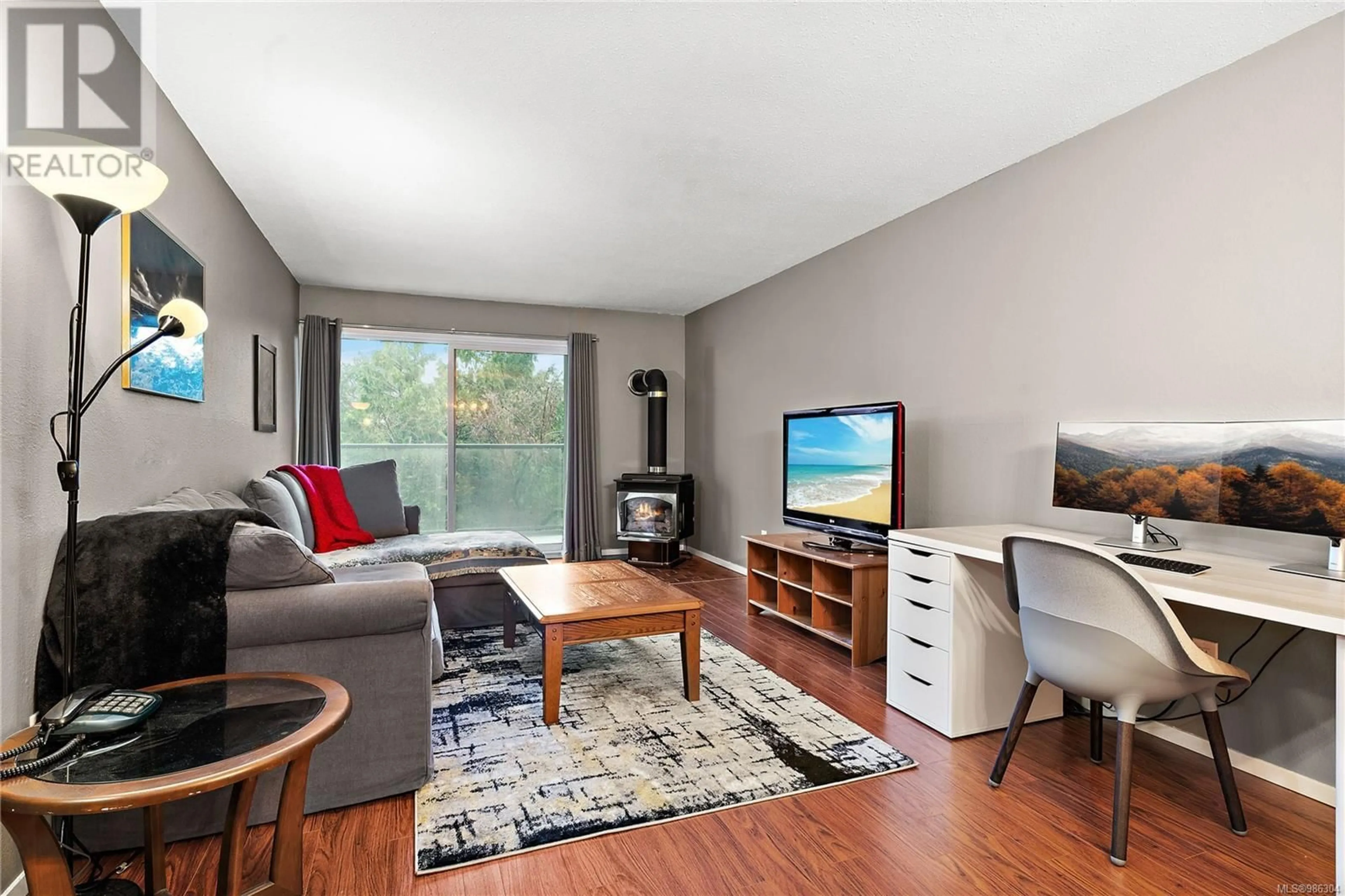 Living room with furniture, wood/laminate floor for 205 2022 Foul Bay Rd, Victoria British Columbia V8R5A9