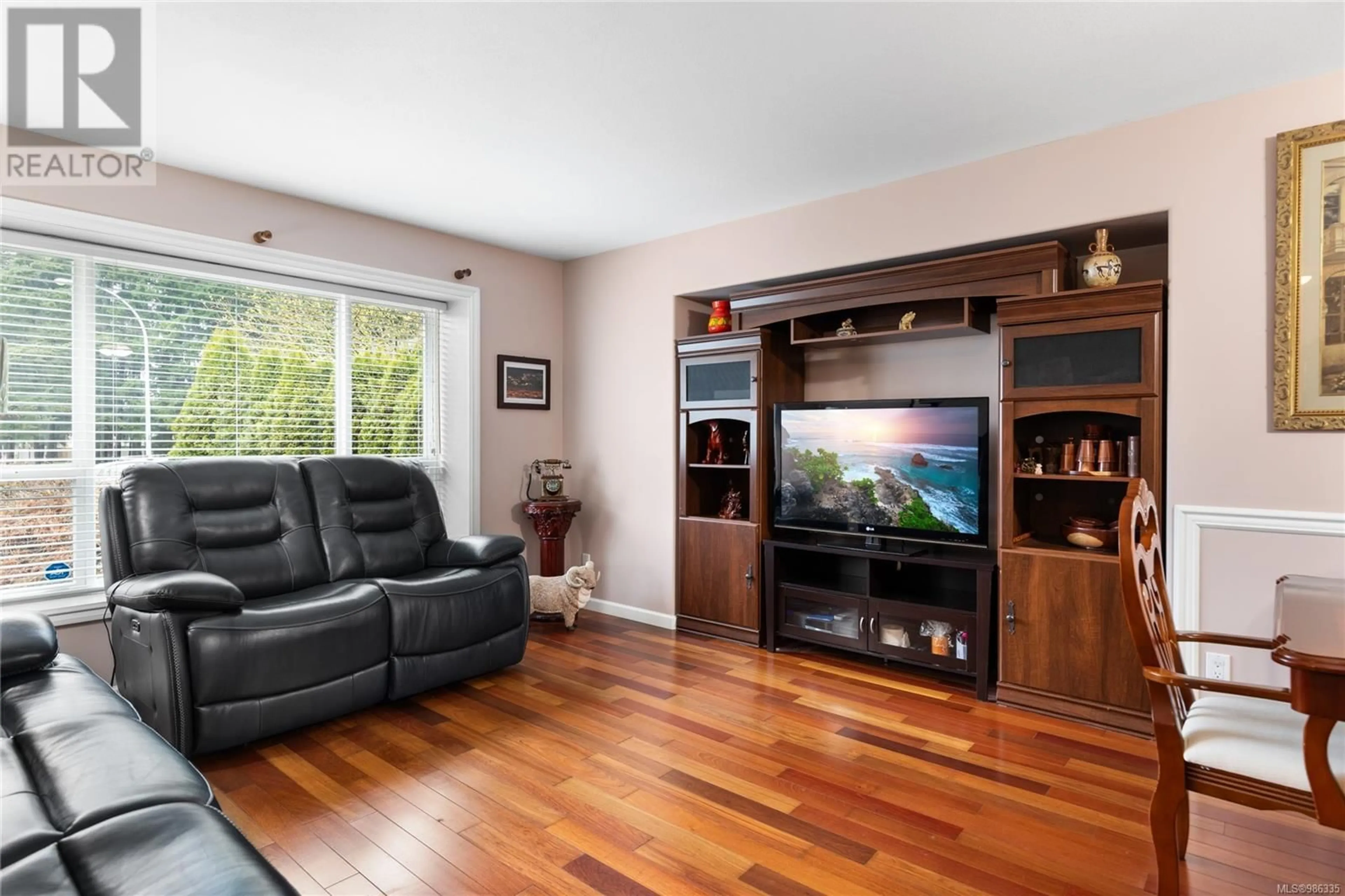 Living room with furniture, wood/laminate floor for 6019 Joseph Pl, Nanaimo British Columbia V9T6H7