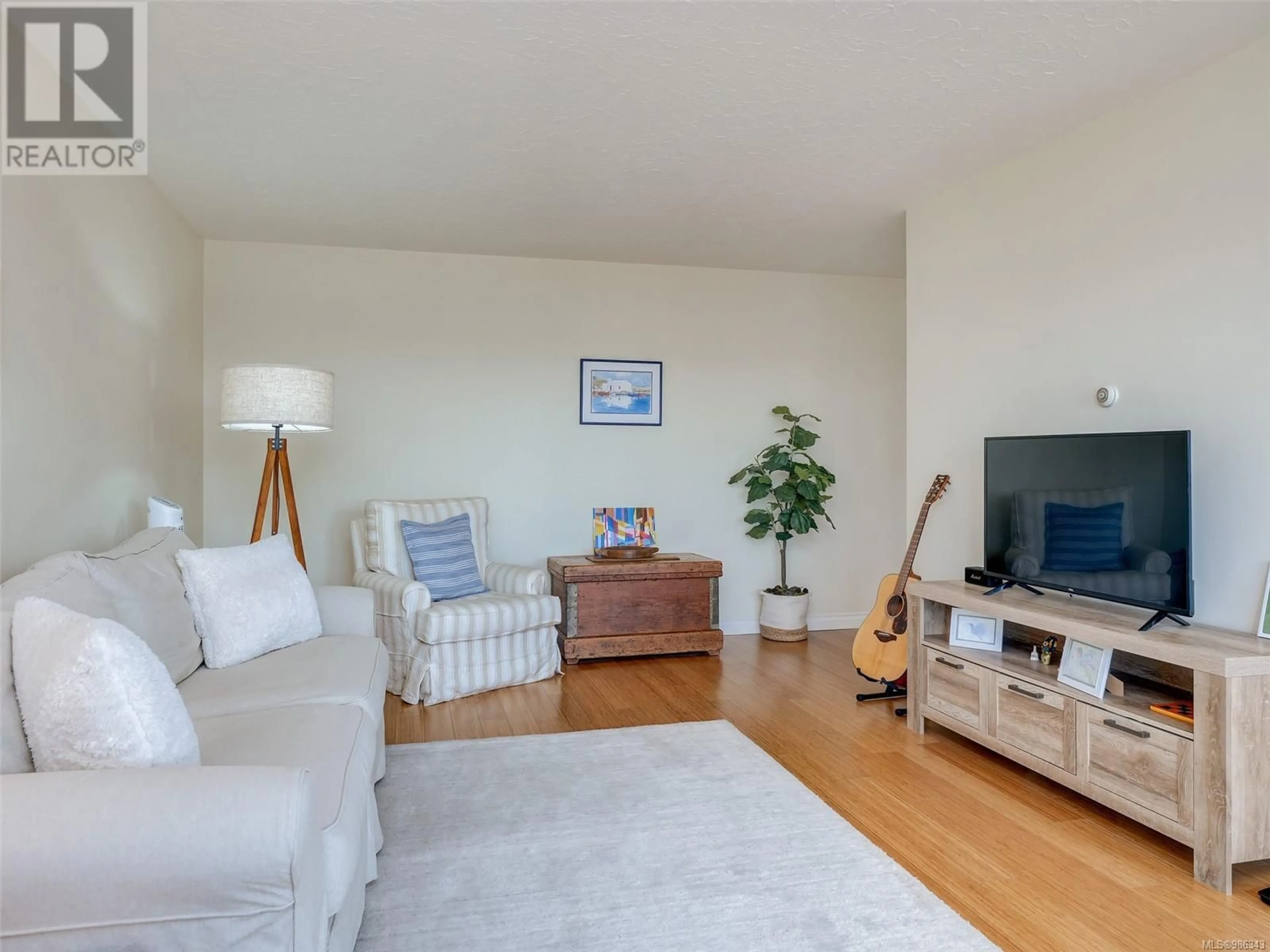 Living room with furniture, wood/laminate floor for 1101 250 Douglas St, Victoria British Columbia V8V2P4