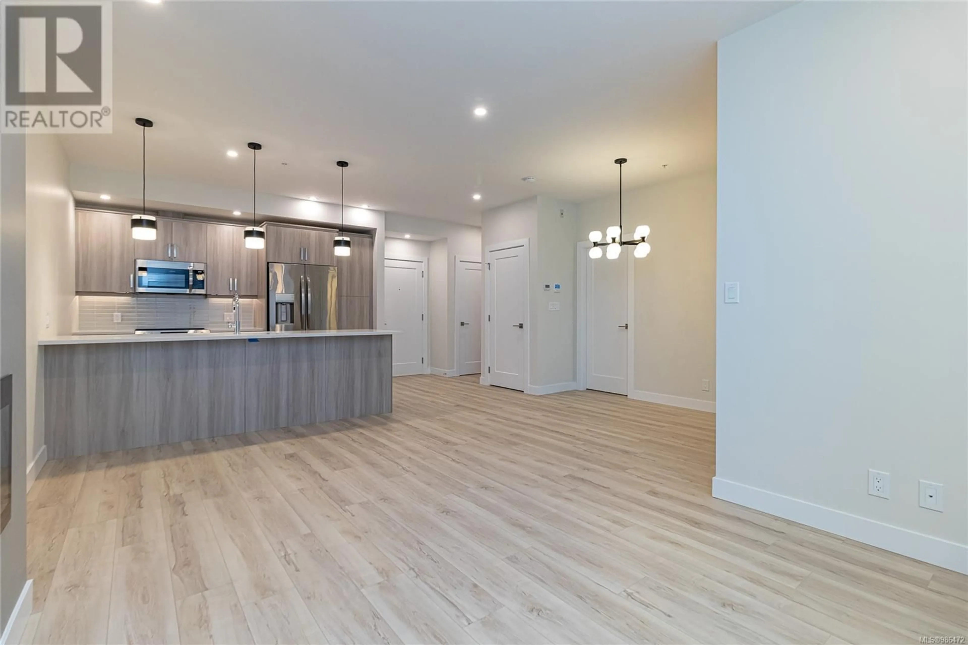 Open concept kitchen, wood/laminate floor for 405 - 918 JENKINS AVENUE, Langford British Columbia V9B2N7