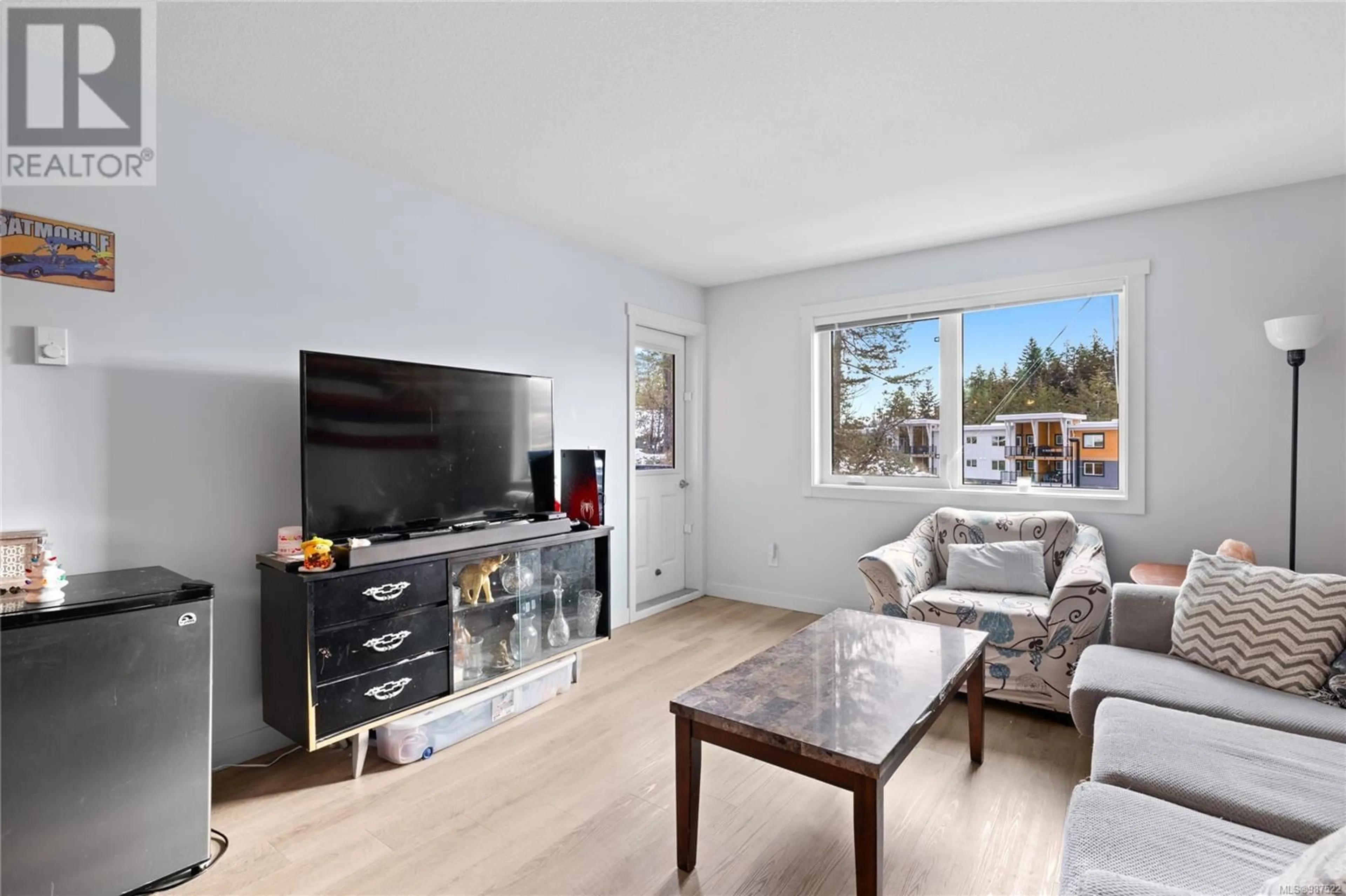 Living room with furniture, wood/laminate floor for 312 4810 Cedar Ridge Pl, Nanaimo British Columbia V9T0M7