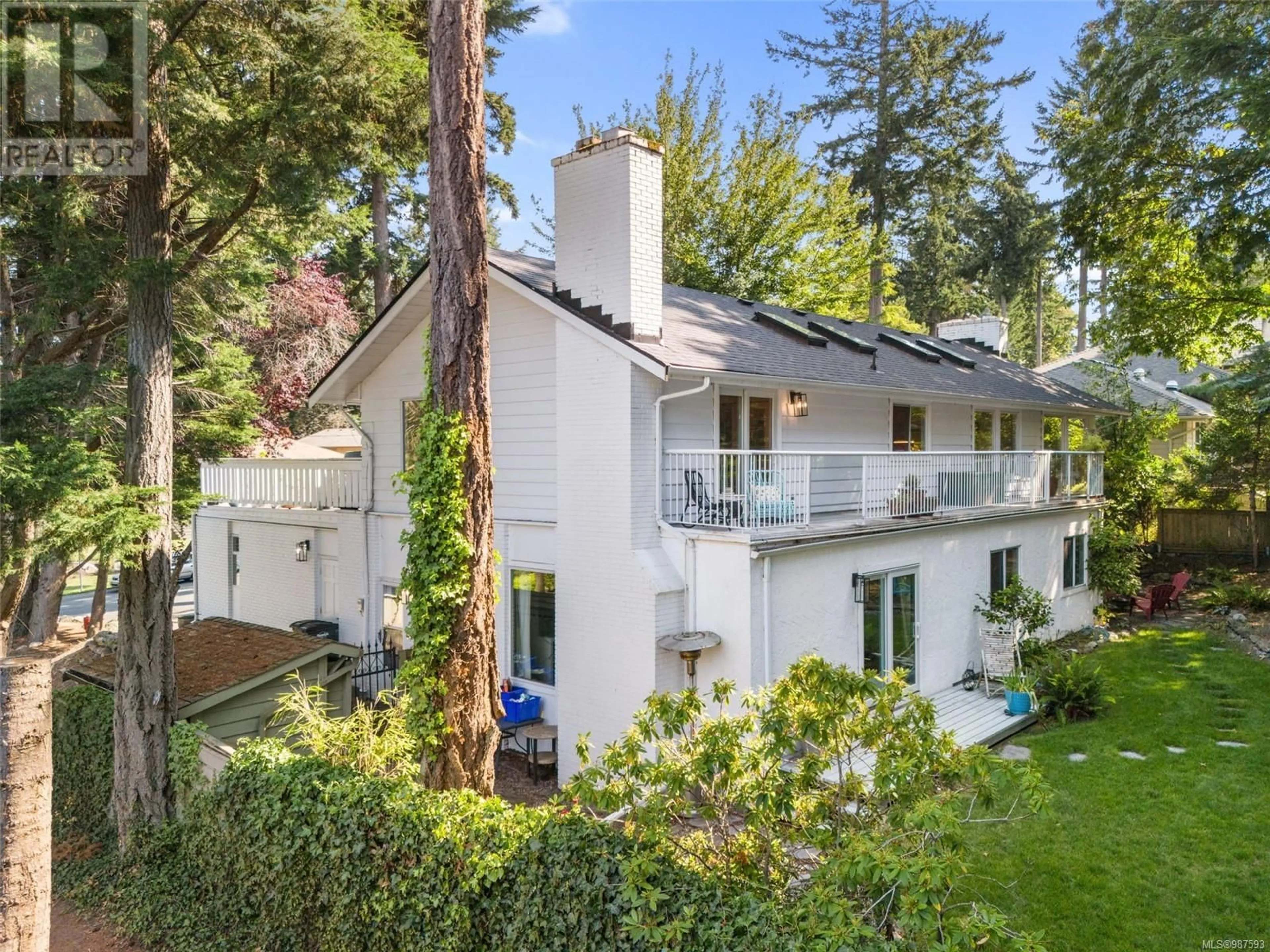 A pic from outside/outdoor area/front of a property/back of a property/a pic from drone, forest/trees view for 4560 Balmacarra Rd, Saanich British Columbia V8N3W3