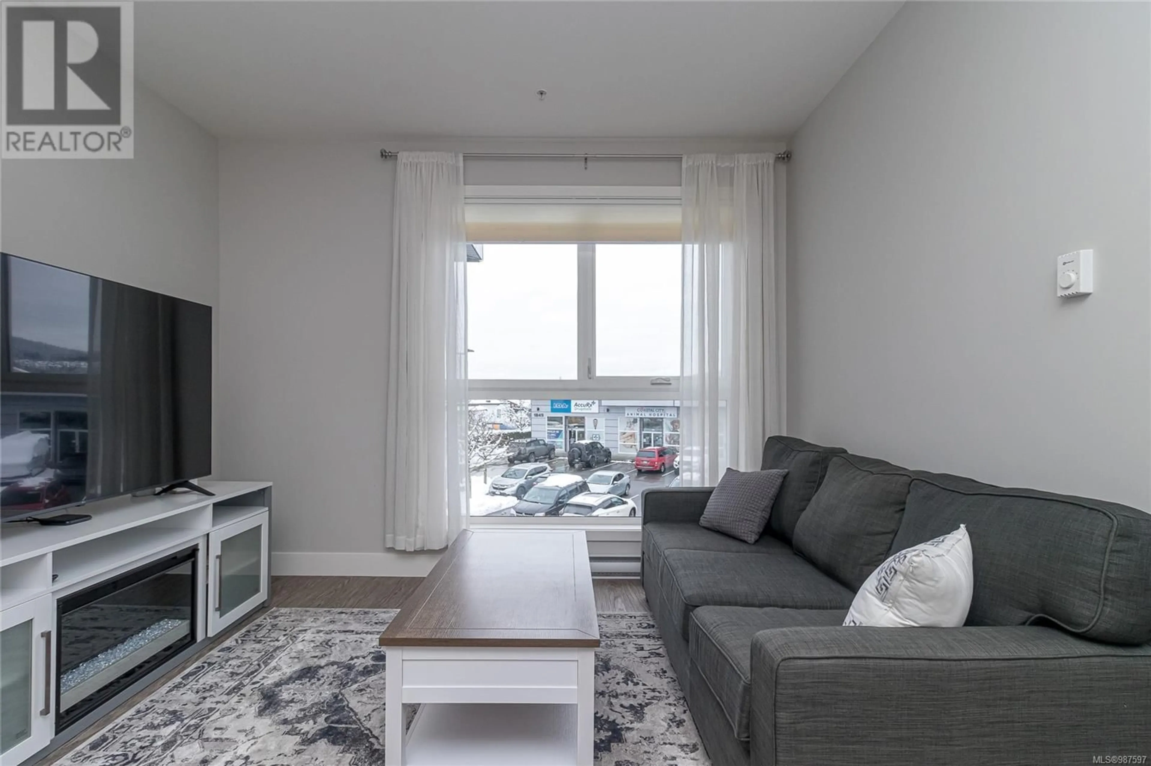 Living room with furniture, wood/laminate floor for 205 1847 Dufferin Cres, Nanaimo British Columbia V9S0B1