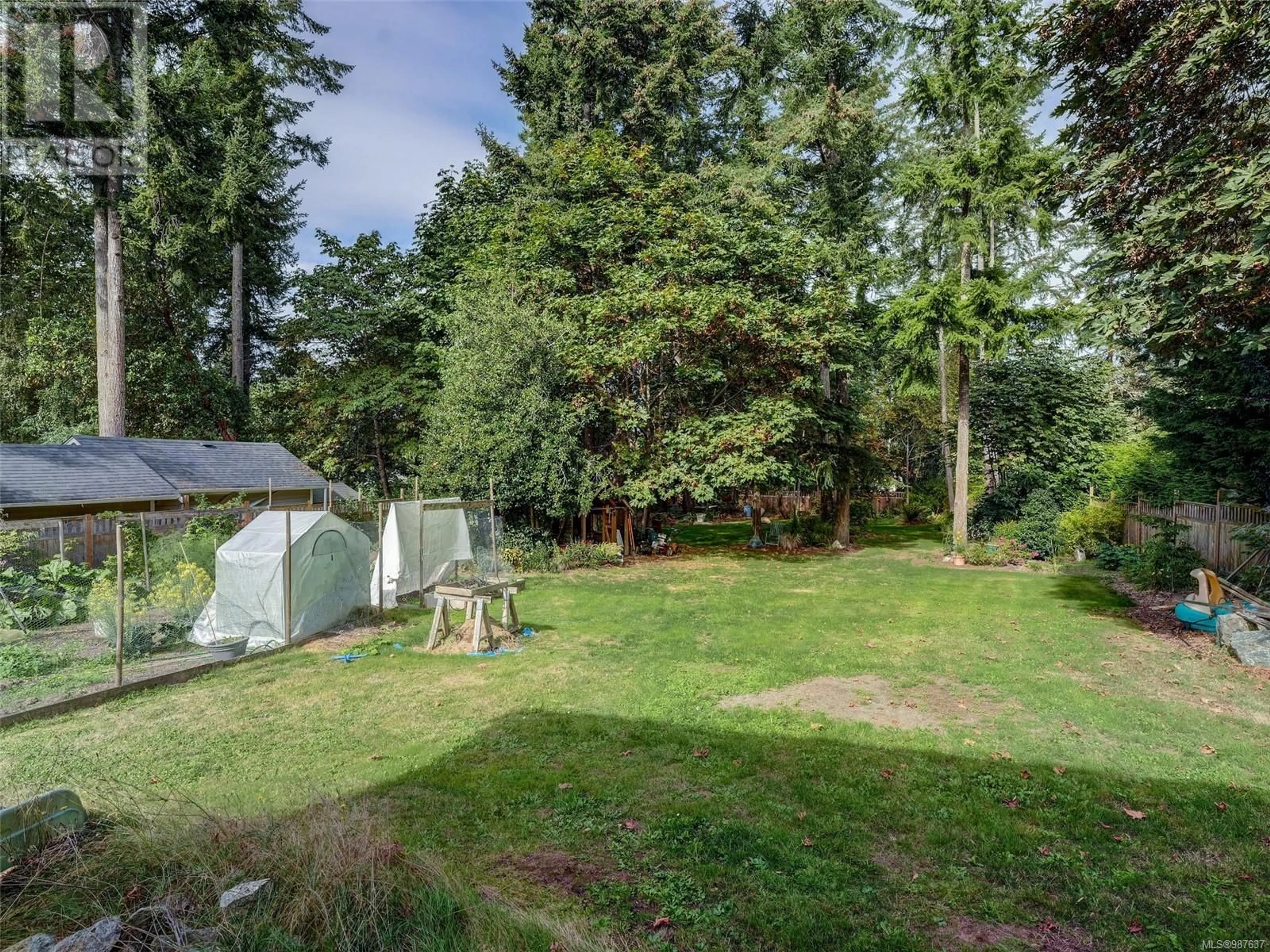 A pic from outside/outdoor area/front of a property/back of a property/a pic from drone, forest/trees view for 548 Cromar Rd, North Saanich British Columbia V8L5M5