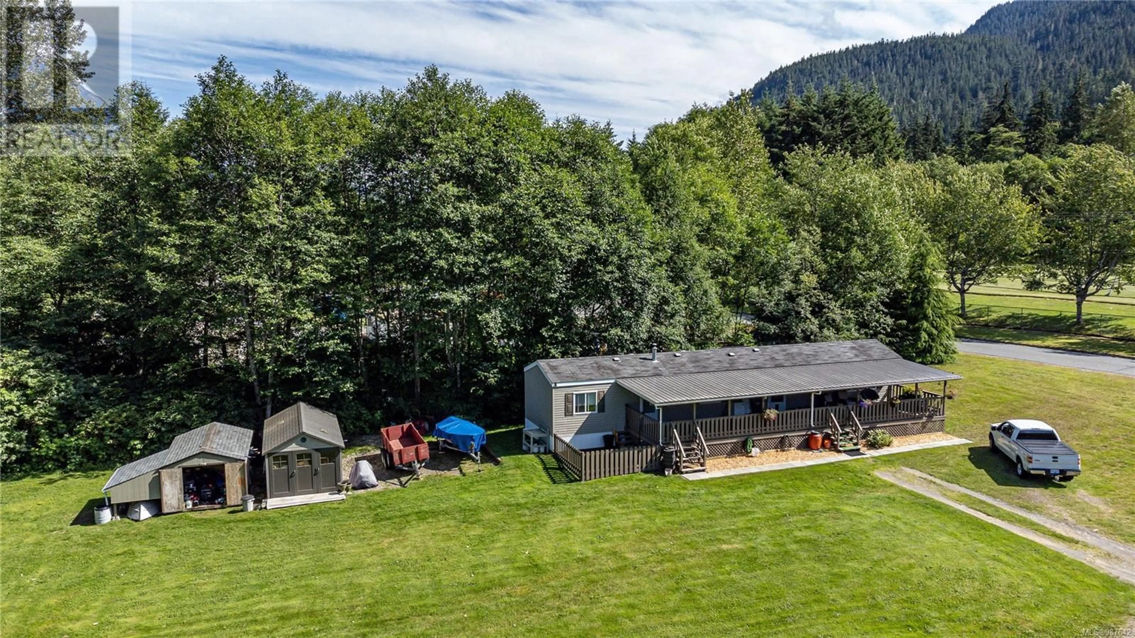 A pic from outside/outdoor area/front of a property/back of a property/a pic from drone, mountain view for 701 Kelsey Way, Sayward British Columbia V0P1R0