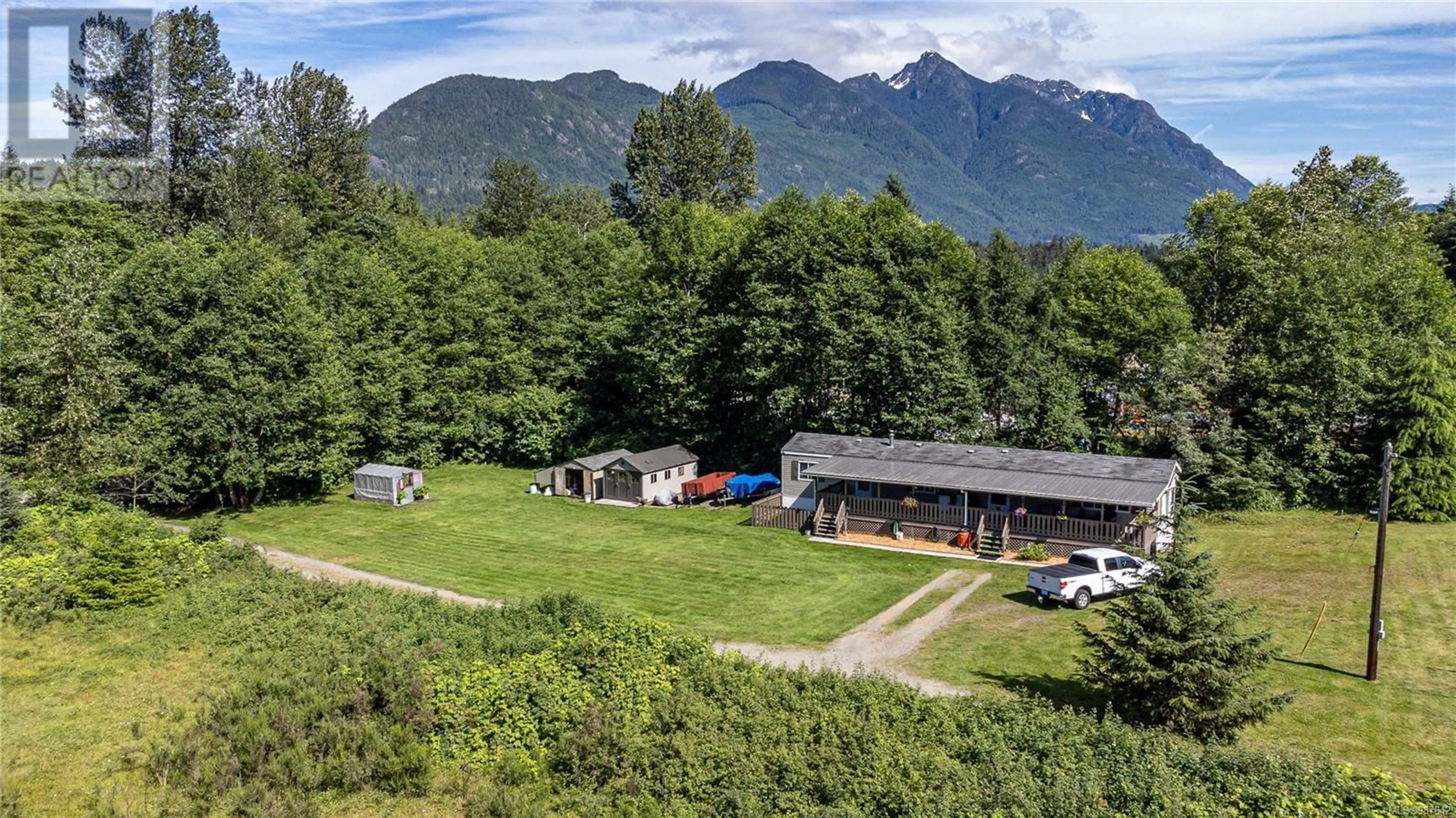 A pic from outside/outdoor area/front of a property/back of a property/a pic from drone, mountain view for 701 Kelsey Way, Sayward British Columbia V0P1R0