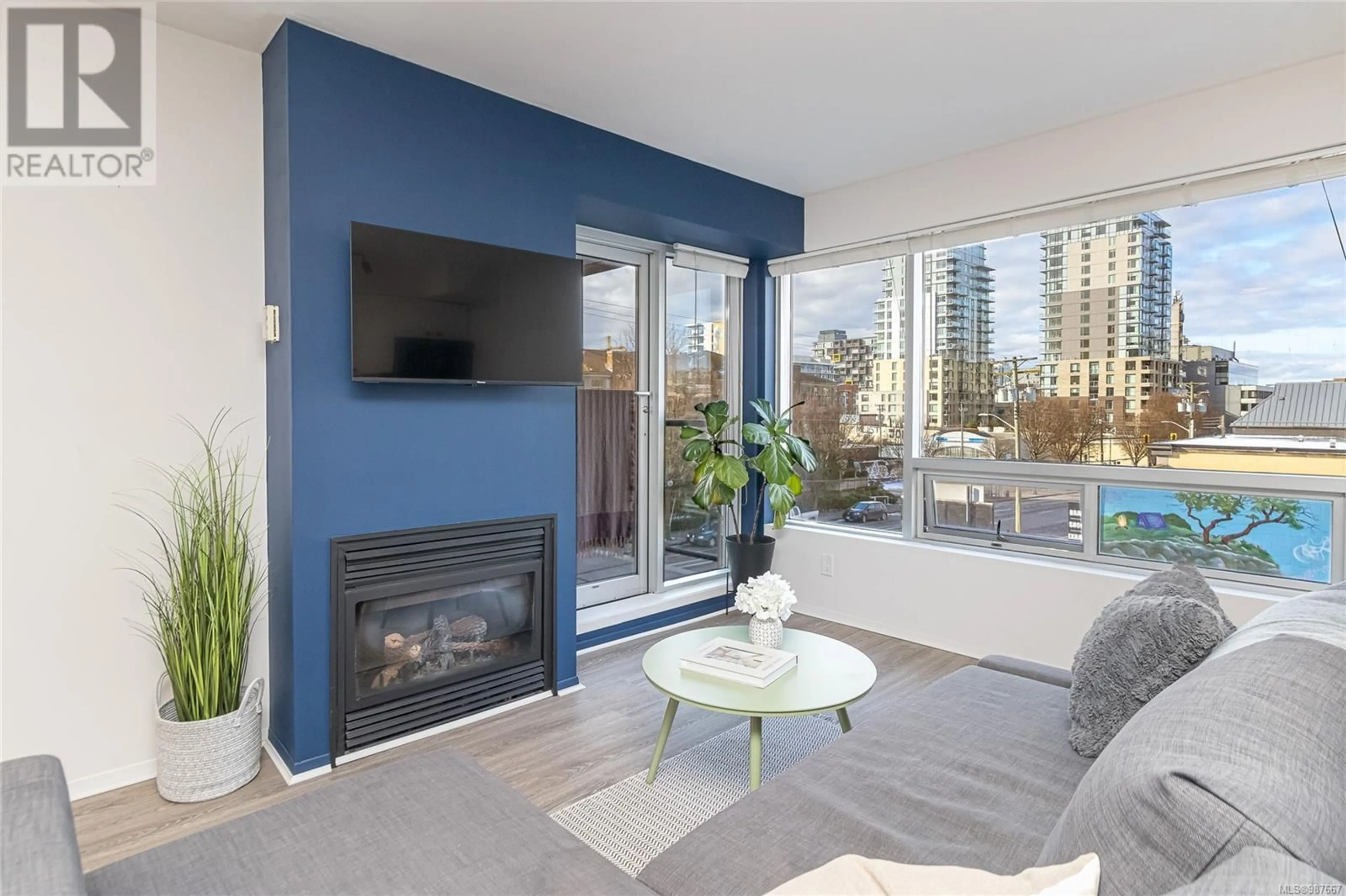 Living room with furniture, wood/laminate floor for 303 932 Johnson St, Victoria British Columbia V8V3N4