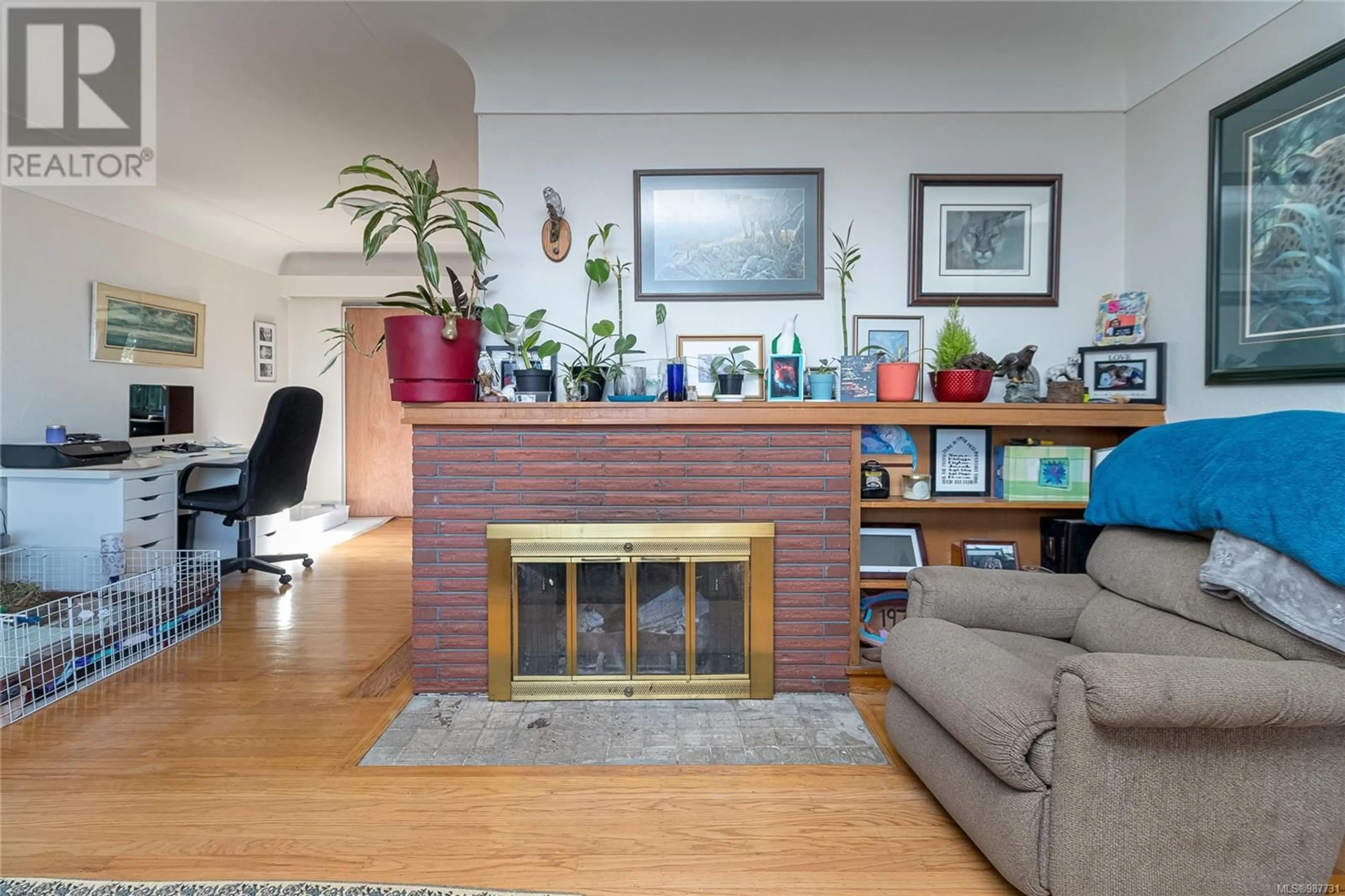 Living room with furniture, wood/laminate floor for 3233 Service St, Saanich British Columbia V8P4M8