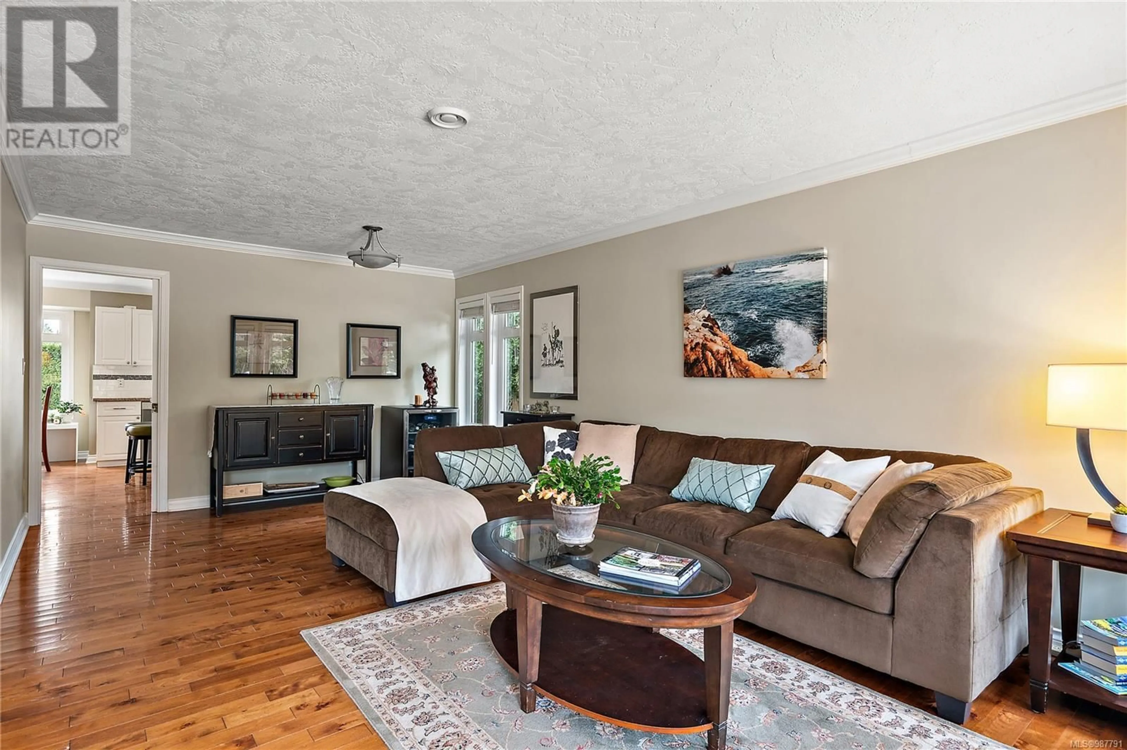 Living room with furniture, wood/laminate floor for 1695 Longacre Dr, Saanich British Columbia V8N2M9