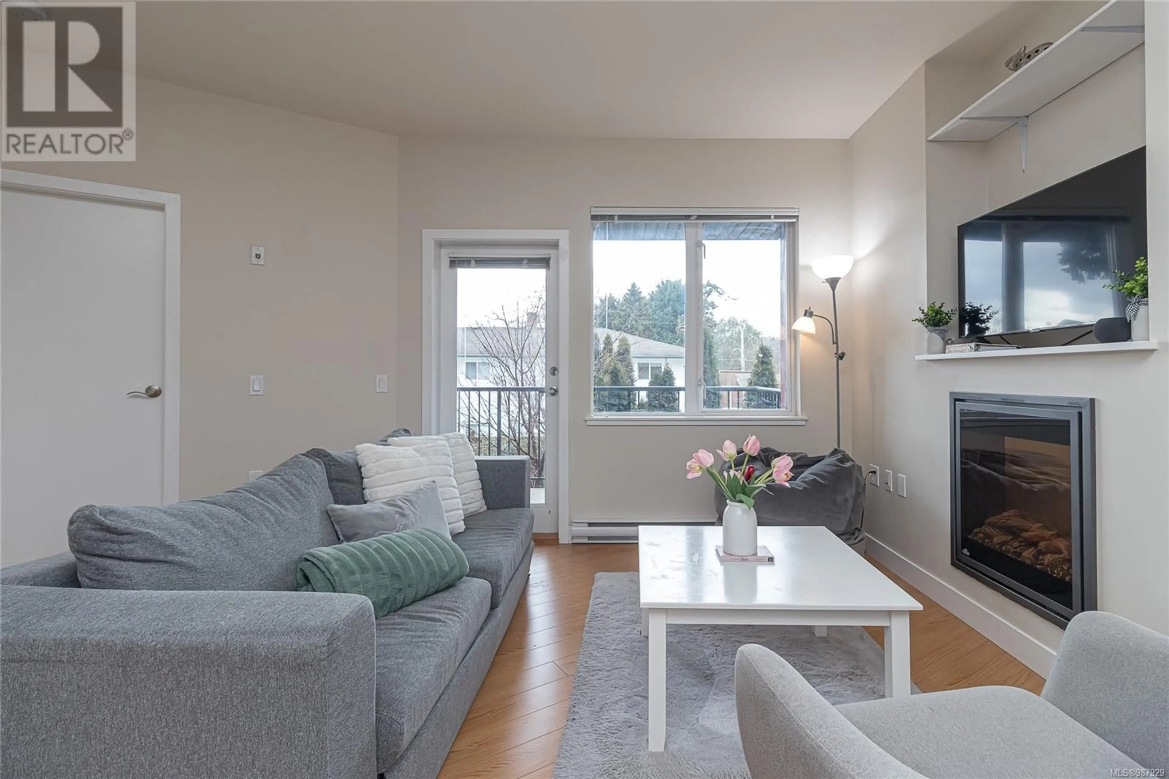 Living room with furniture, wood/laminate floor for 204 4040 Borden St, Saanich British Columbia V8X2E9