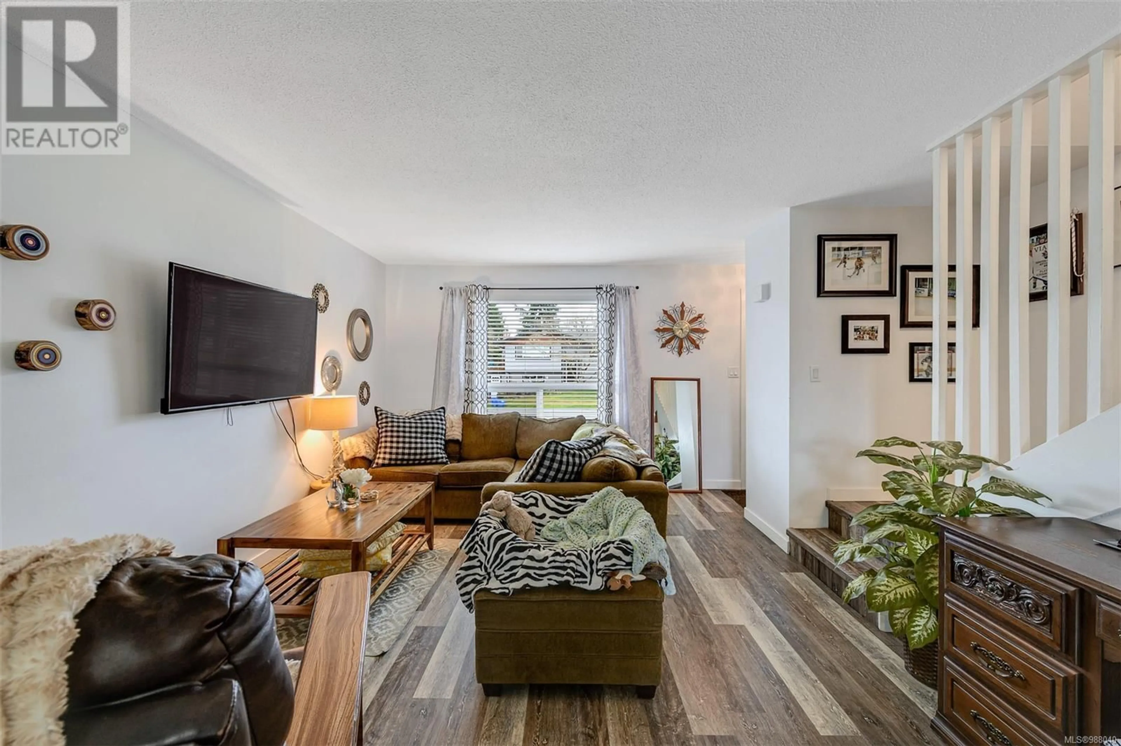 Living room with furniture, wood/laminate floor for 2031/2033 Melville Dr, Sidney British Columbia V8L2N2