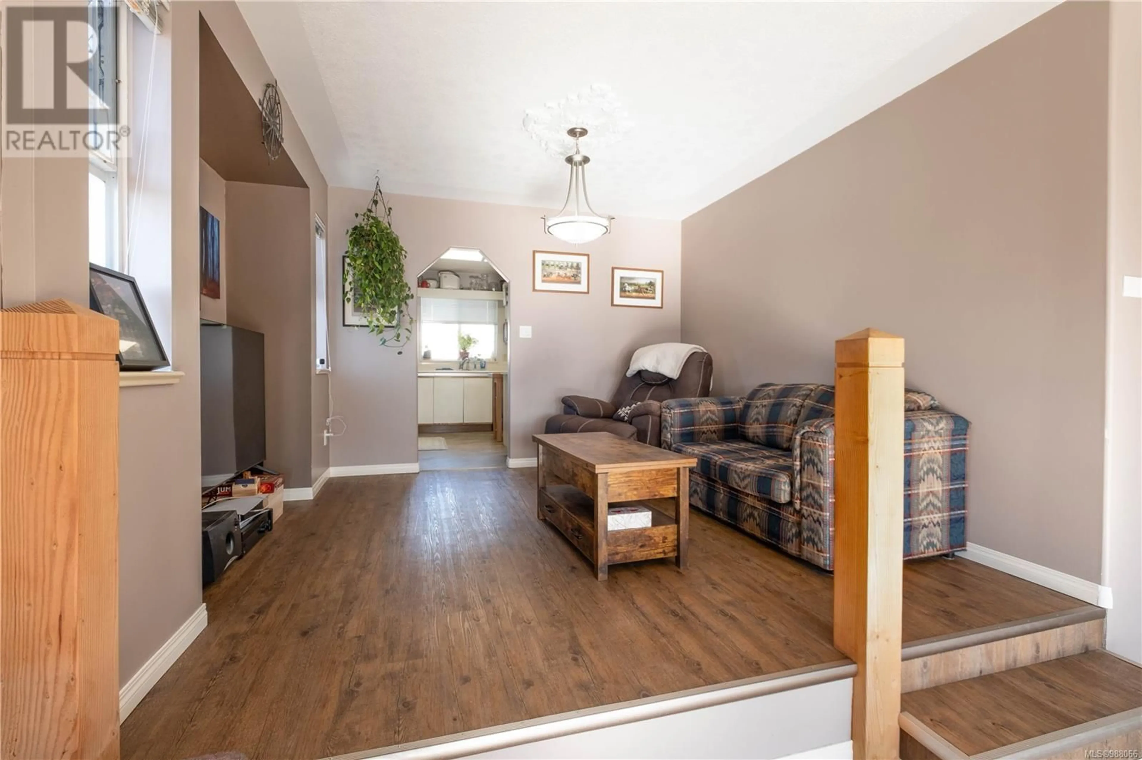 Living room with furniture, wood/laminate floor for 828 Merecroft Rd, Campbell River British Columbia V9W7J6