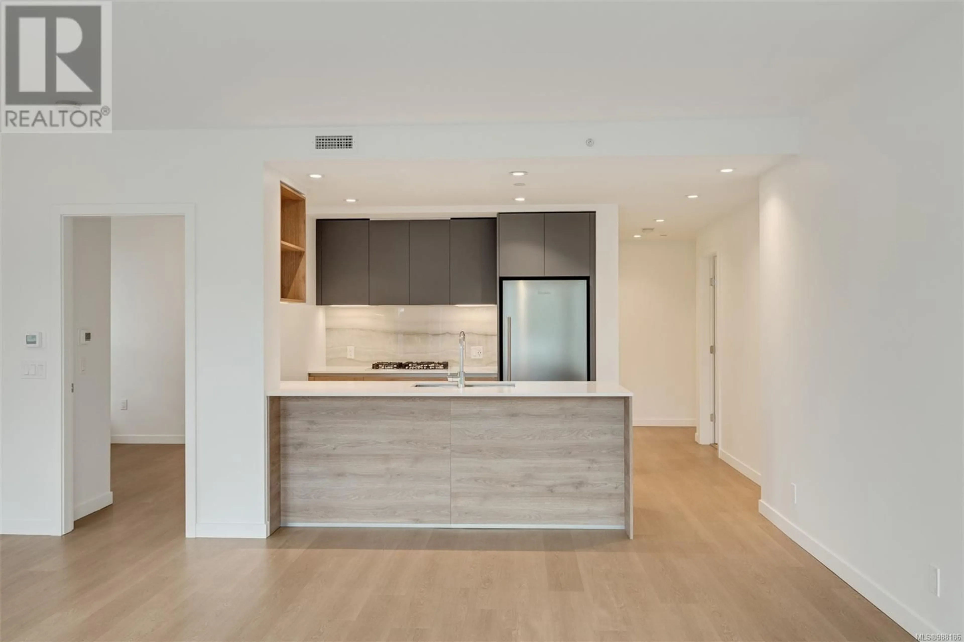 Open concept kitchen, wood/laminate floor for 208 - 369 TYEE ROAD, Victoria British Columbia V9A0B6
