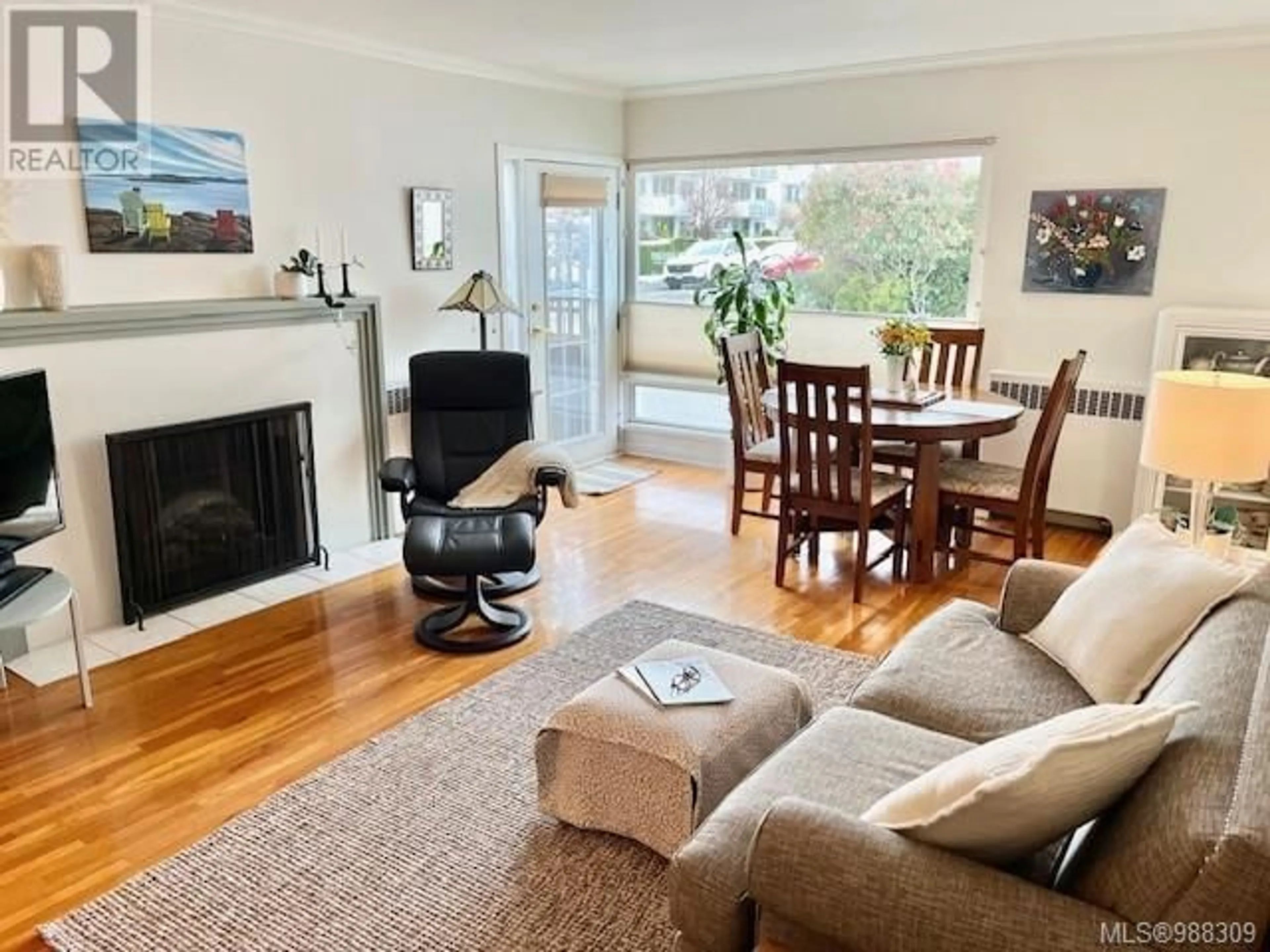 Living room with furniture, wood/laminate floor for 101 2660 Currie Rd, Oak Bay British Columbia V8S3C1