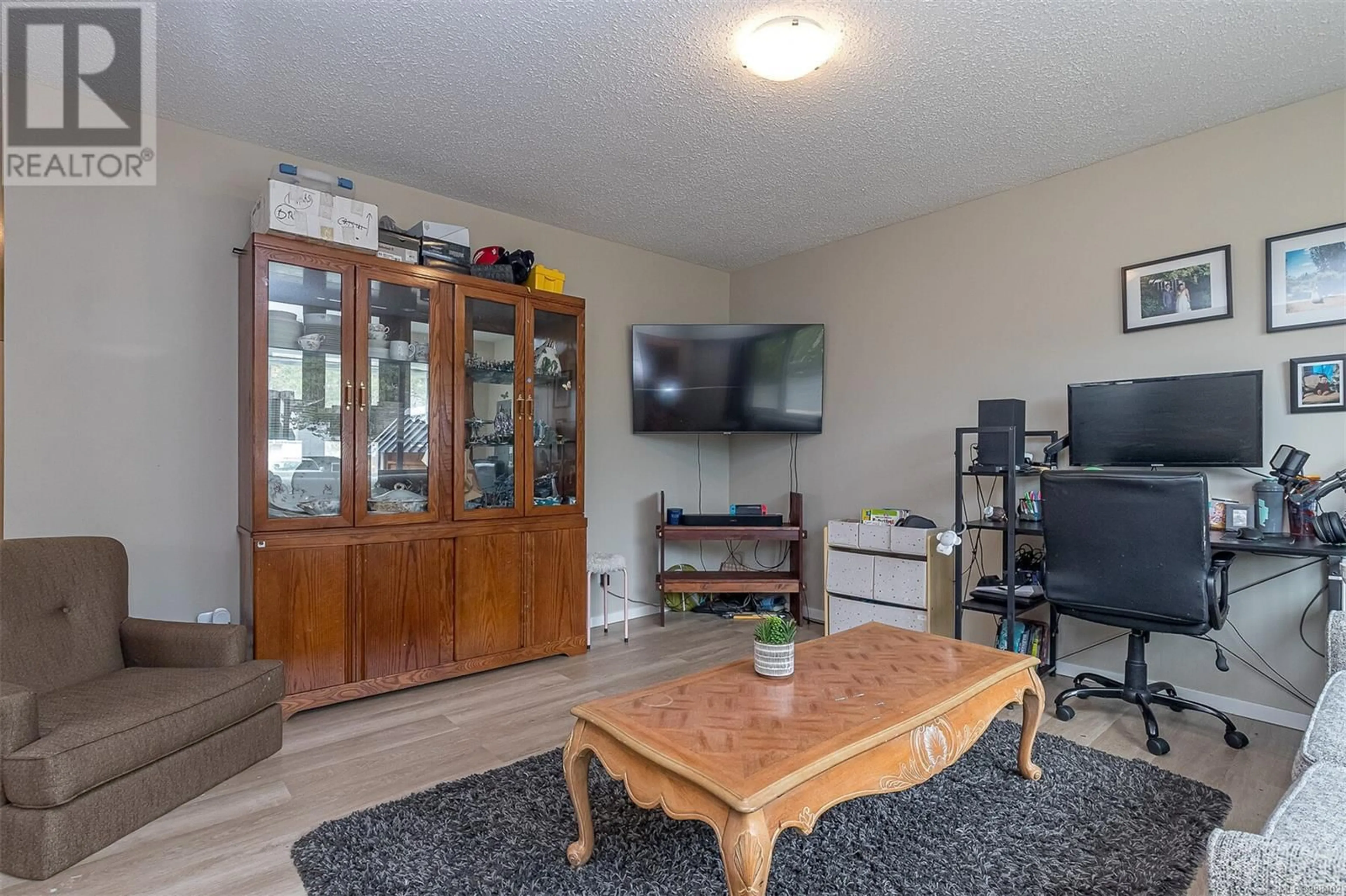 Living room with furniture, wood/laminate floor for 2189A &2189B Amelia Ave, Sidney British Columbia V8L2H5