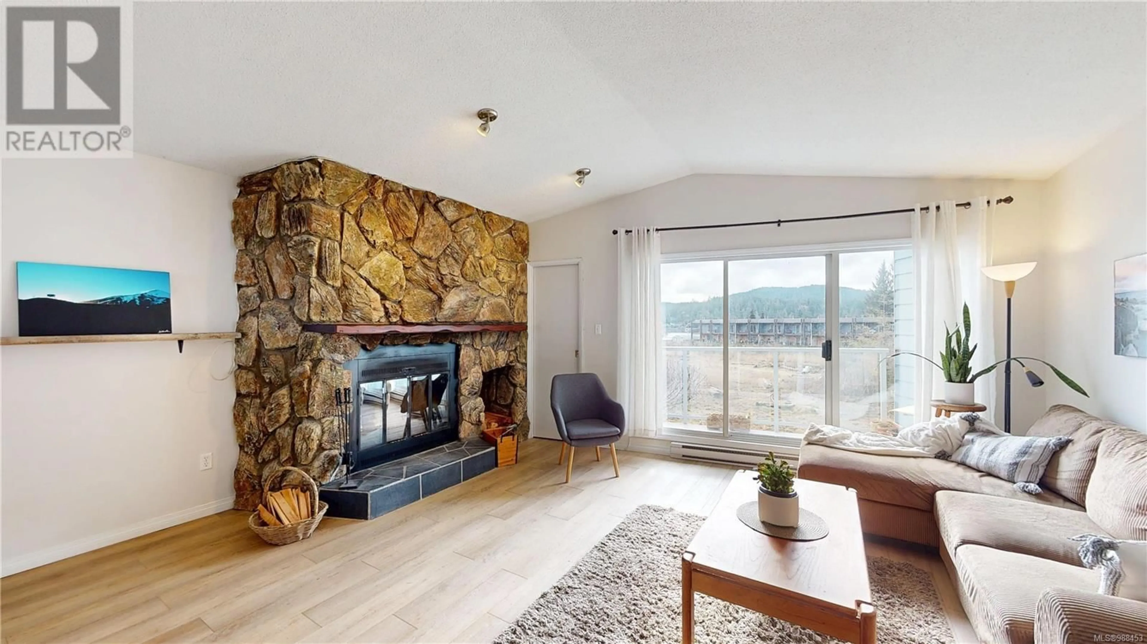 Living room with furniture, wood/laminate floor for 11 6110 Seabroom Rd, Sooke British Columbia V9Z0B8