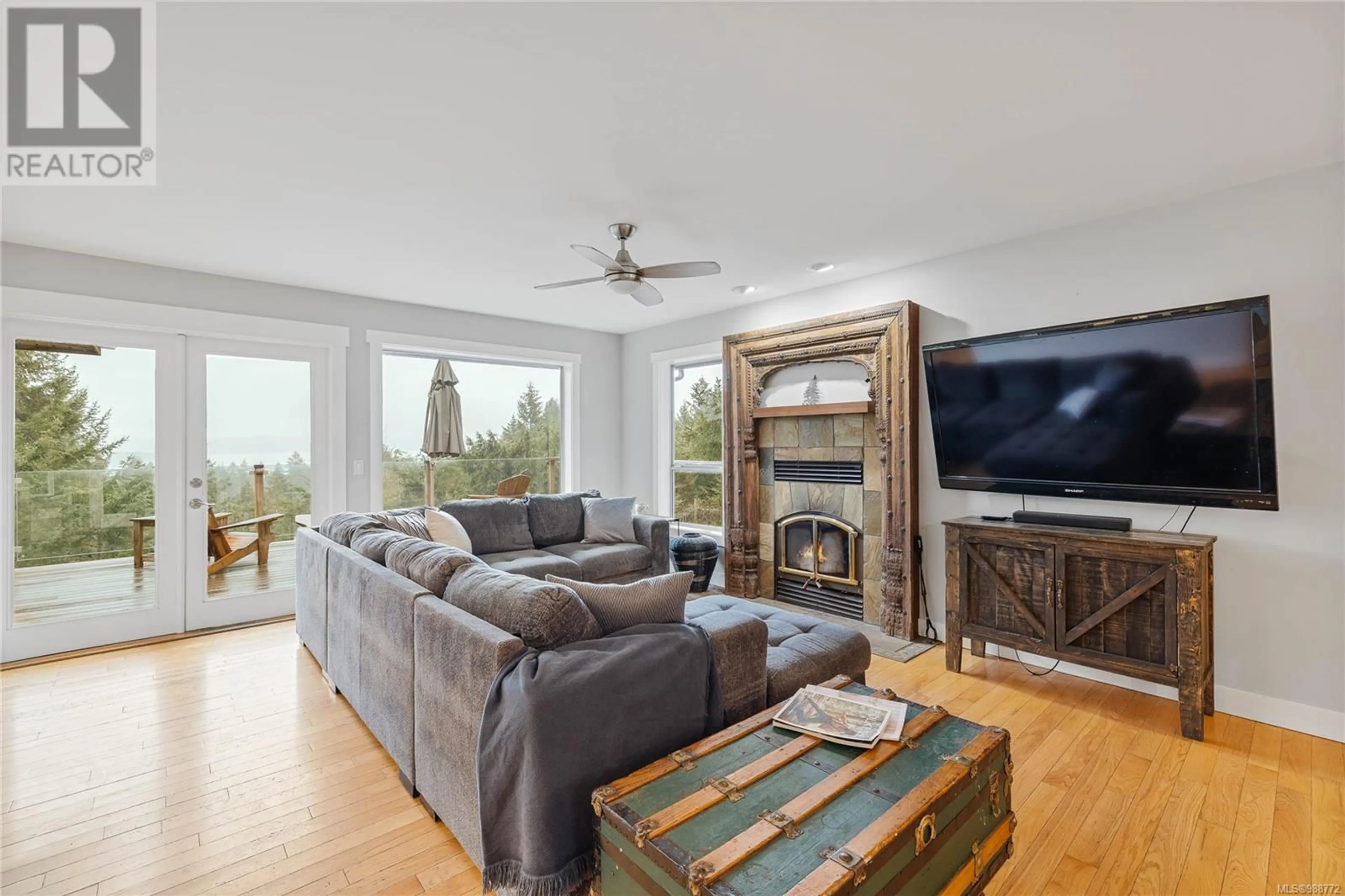 Living room with furniture, wood/laminate floor for 2265 North End Rd, Salt Spring British Columbia V8K1A7