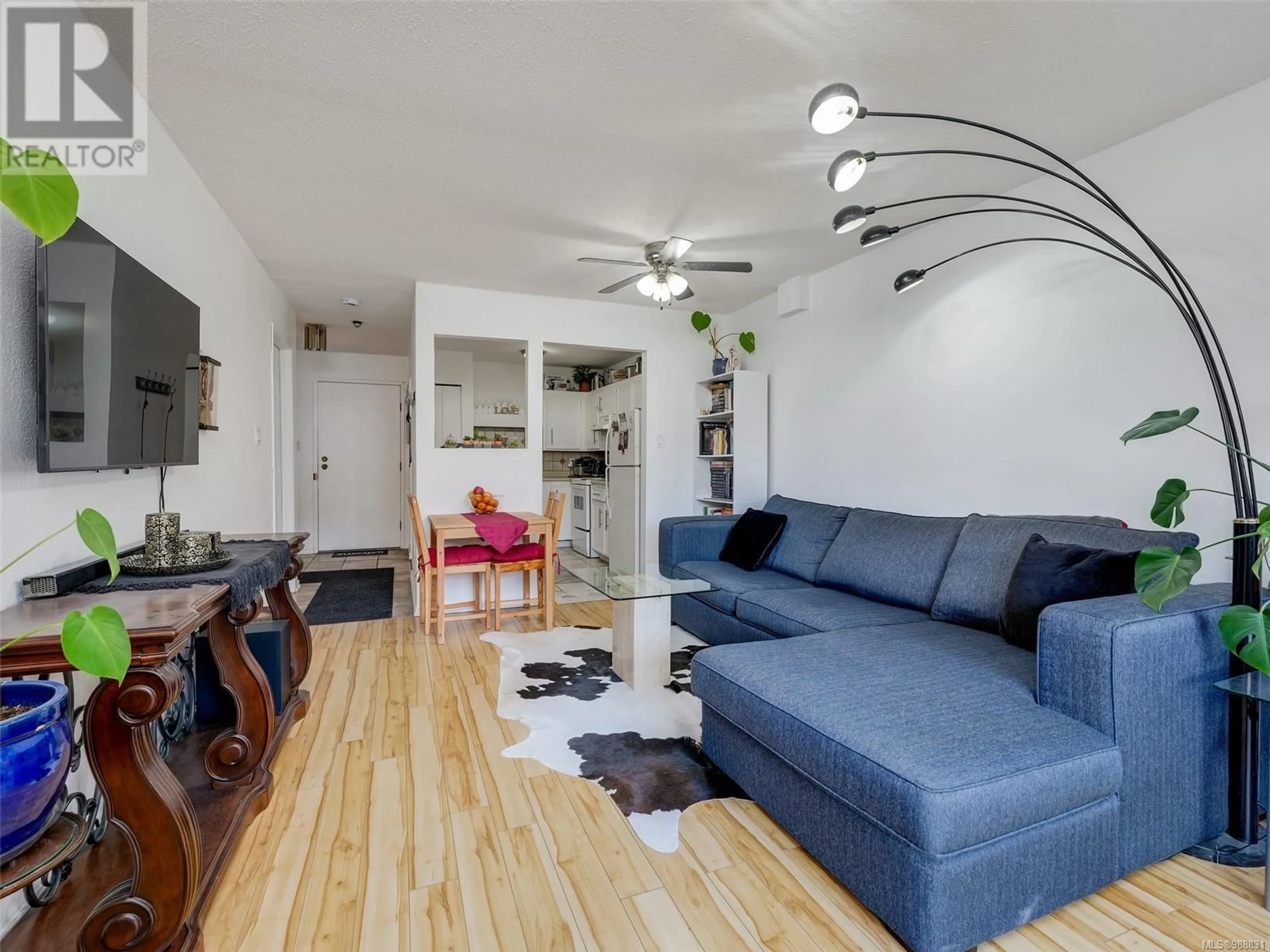 Living room with furniture, wood/laminate floor for 110 3252 Glasgow Ave, Saanich British Columbia V8X1M2