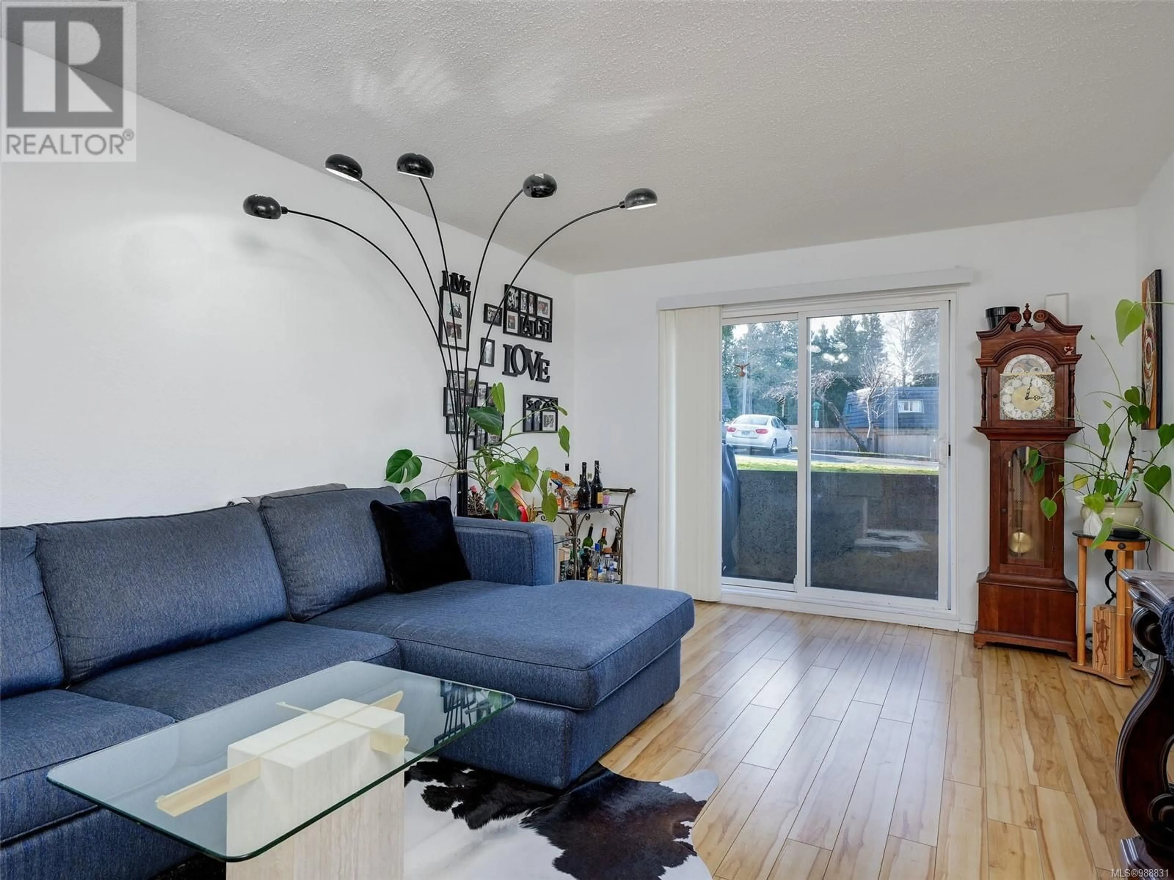 Living room with furniture, wood/laminate floor for 110 3252 Glasgow Ave, Saanich British Columbia V8X1M2