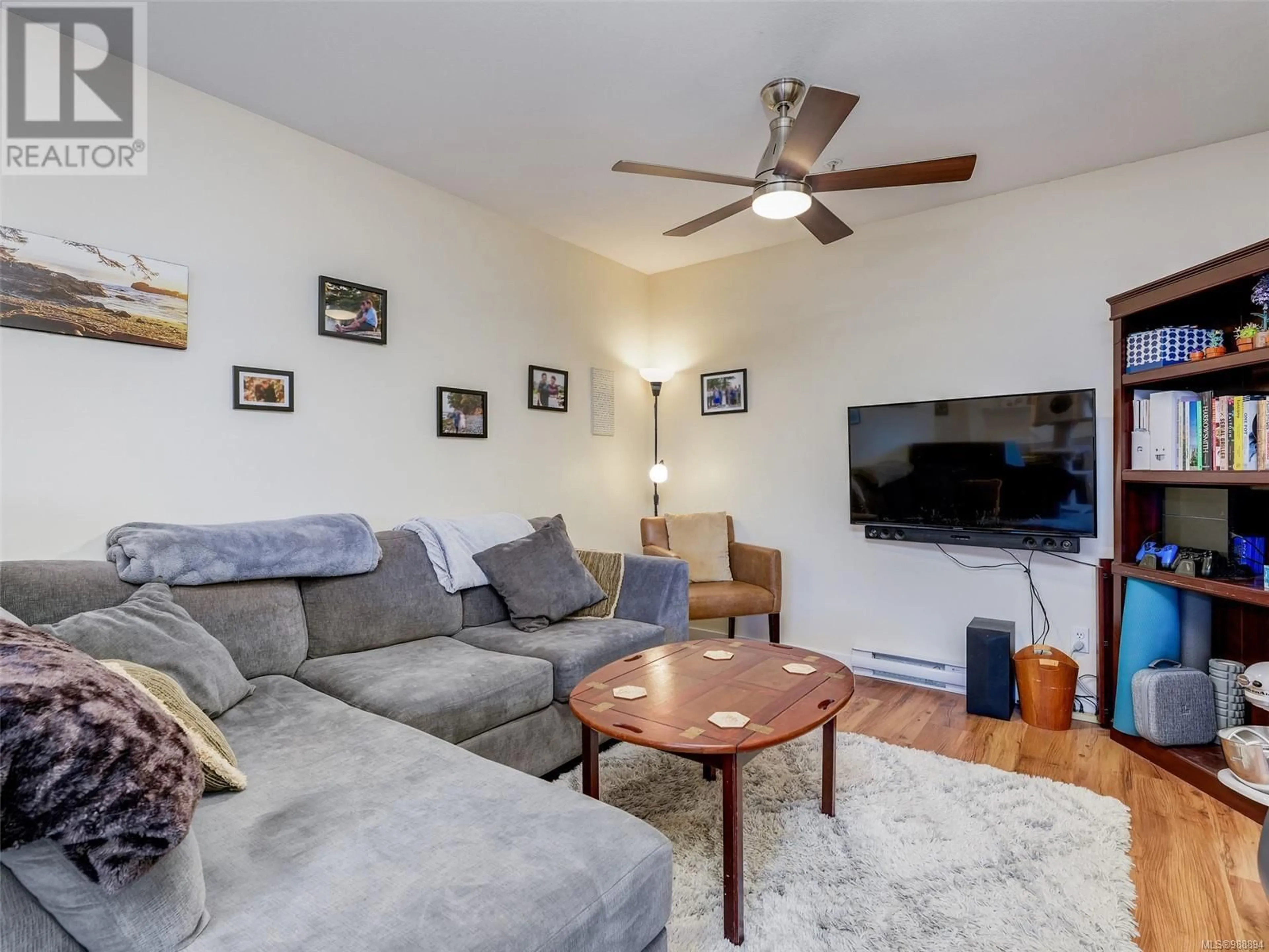 Living room with furniture, wood/laminate floor for 401 7 Gorge Rd W, Saanich British Columbia V9A1L9