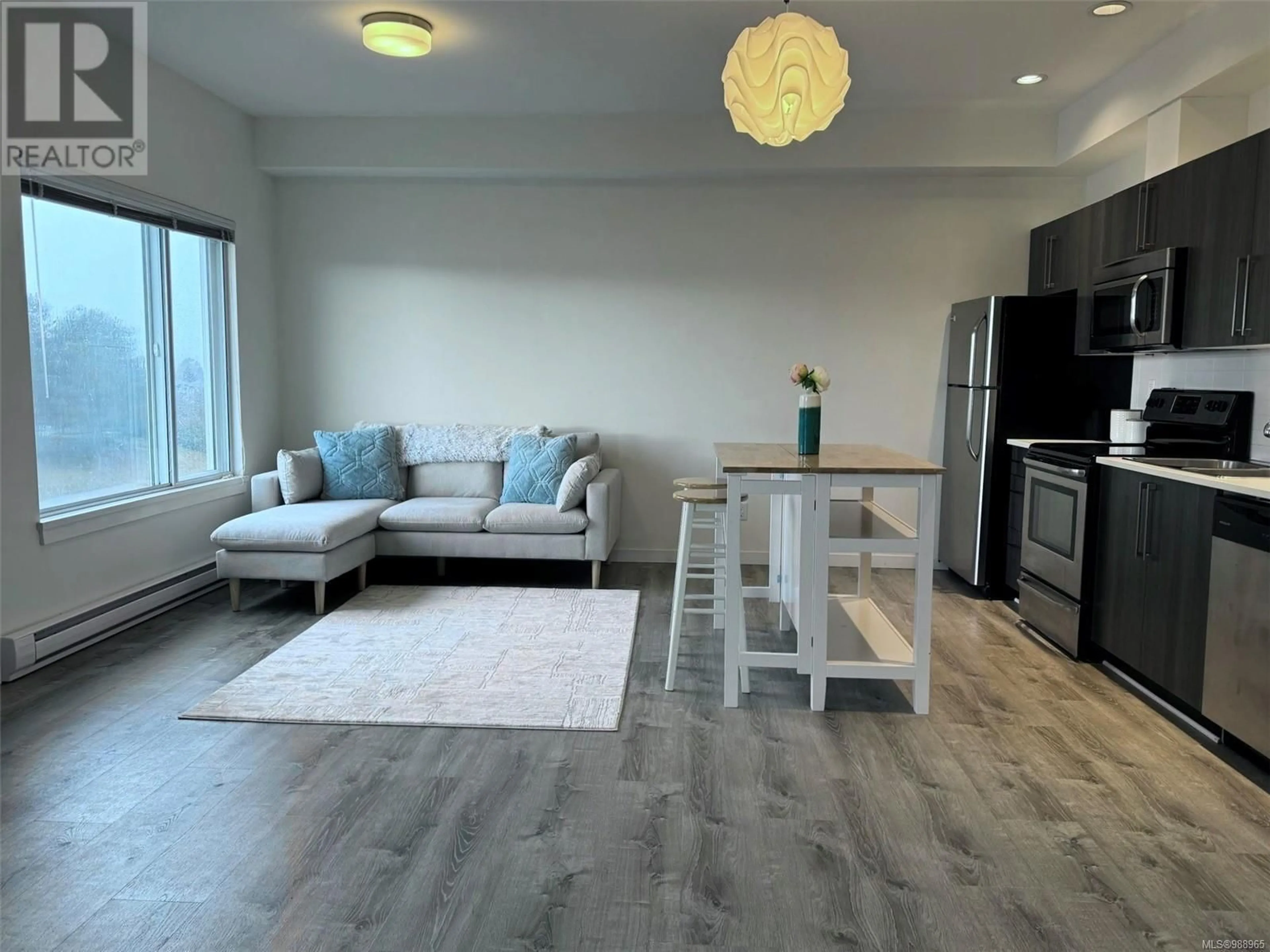 Living room with furniture, wood/laminate floor for 303 4052 Douglas St, Saanich British Columbia V8X0A5