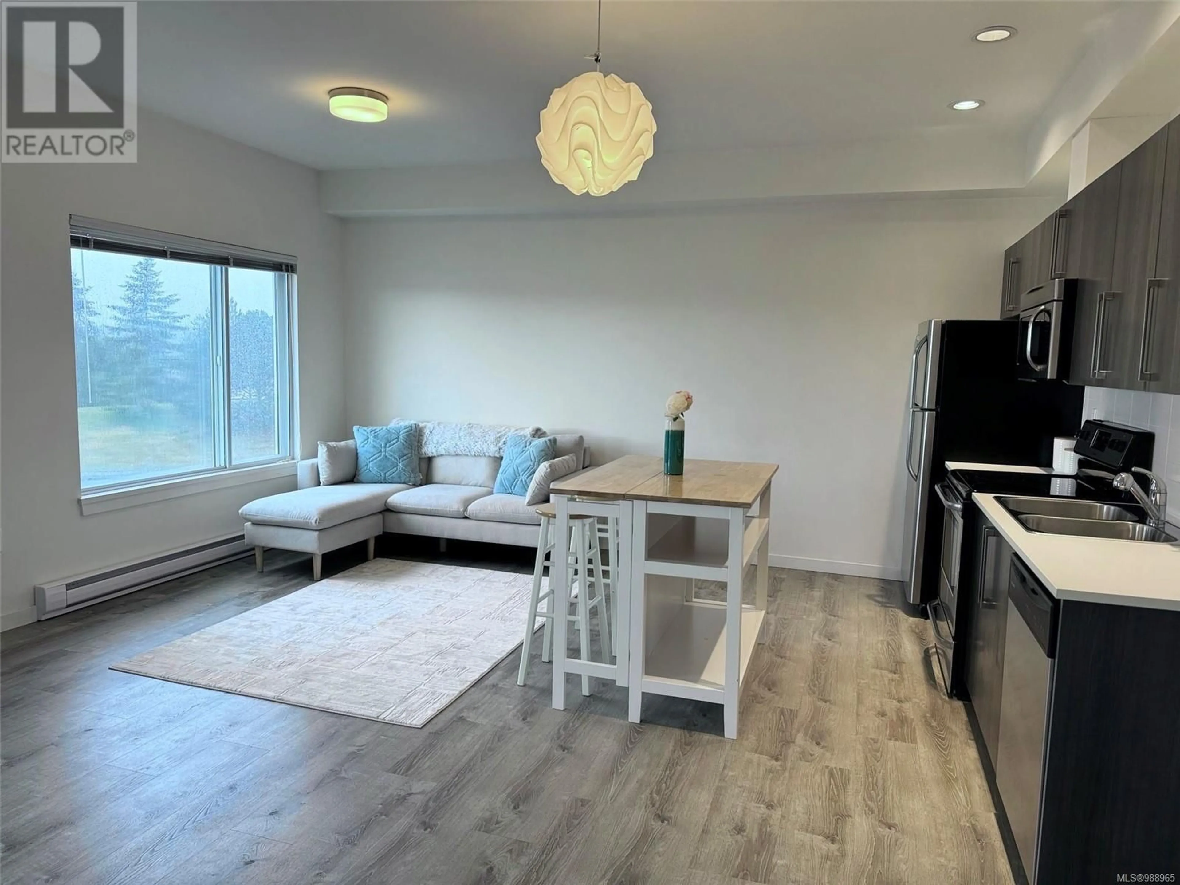 Living room with furniture, wood/laminate floor for 303 4052 Douglas St, Saanich British Columbia V8X0A5