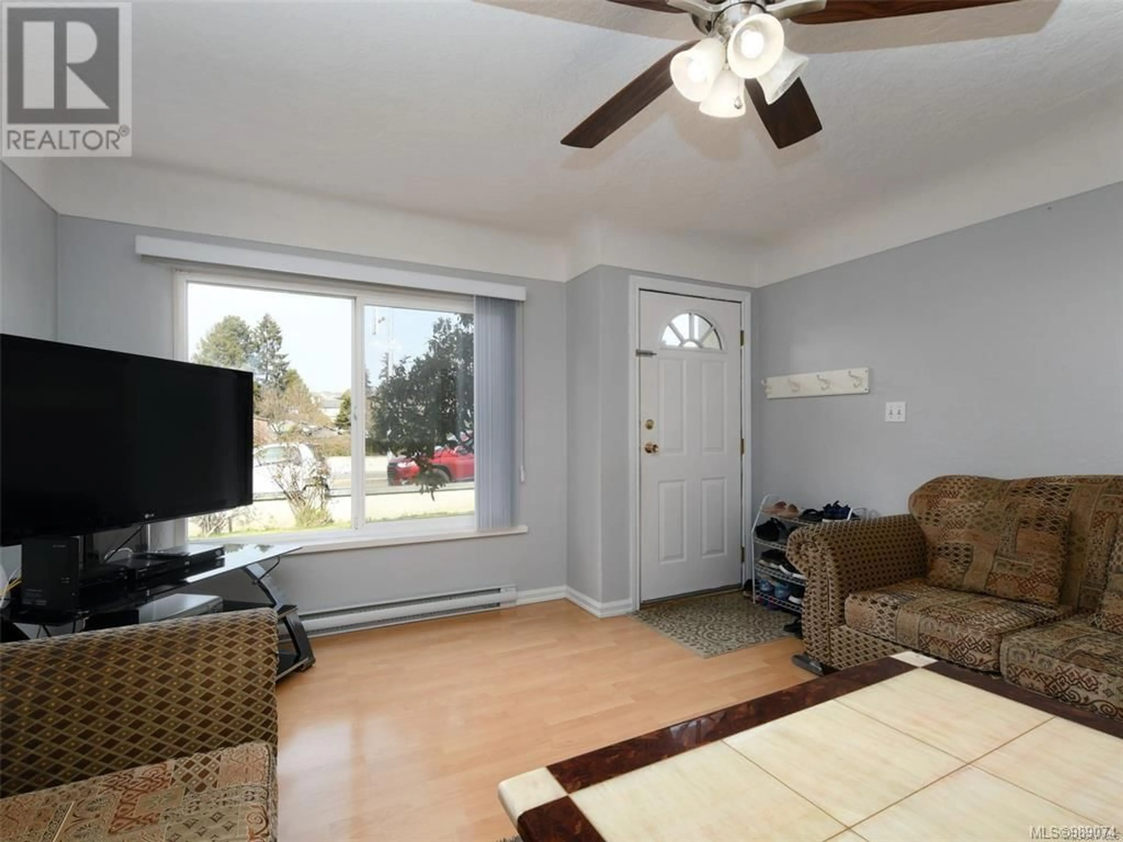 Living room with furniture, wood/laminate floor for 85 Battleford Ave, Saanich British Columbia V8Z1K5