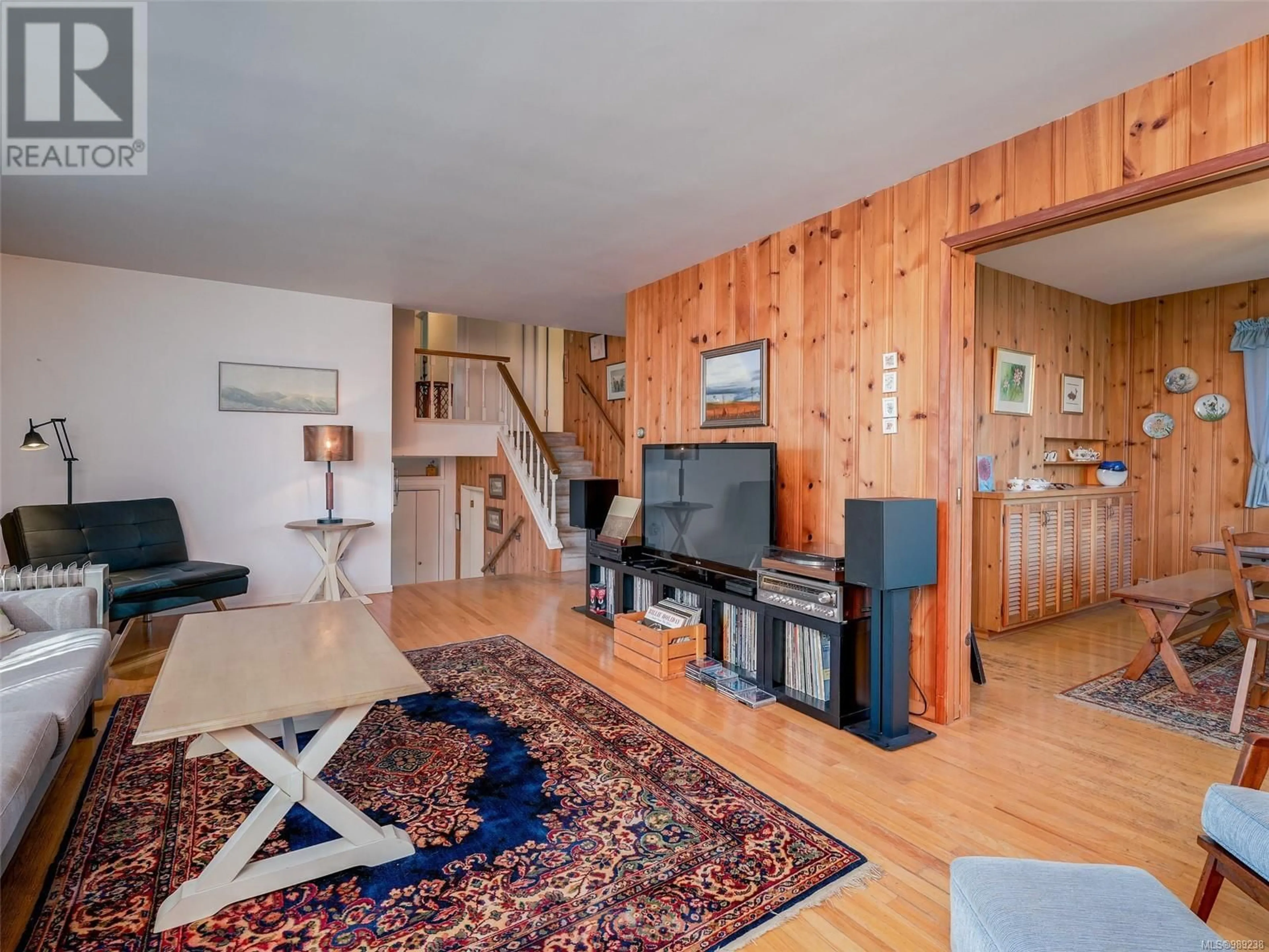 Living room with furniture, wood/laminate floor for 4799 Cordova Bay Rd, Saanich British Columbia V8Y2J8