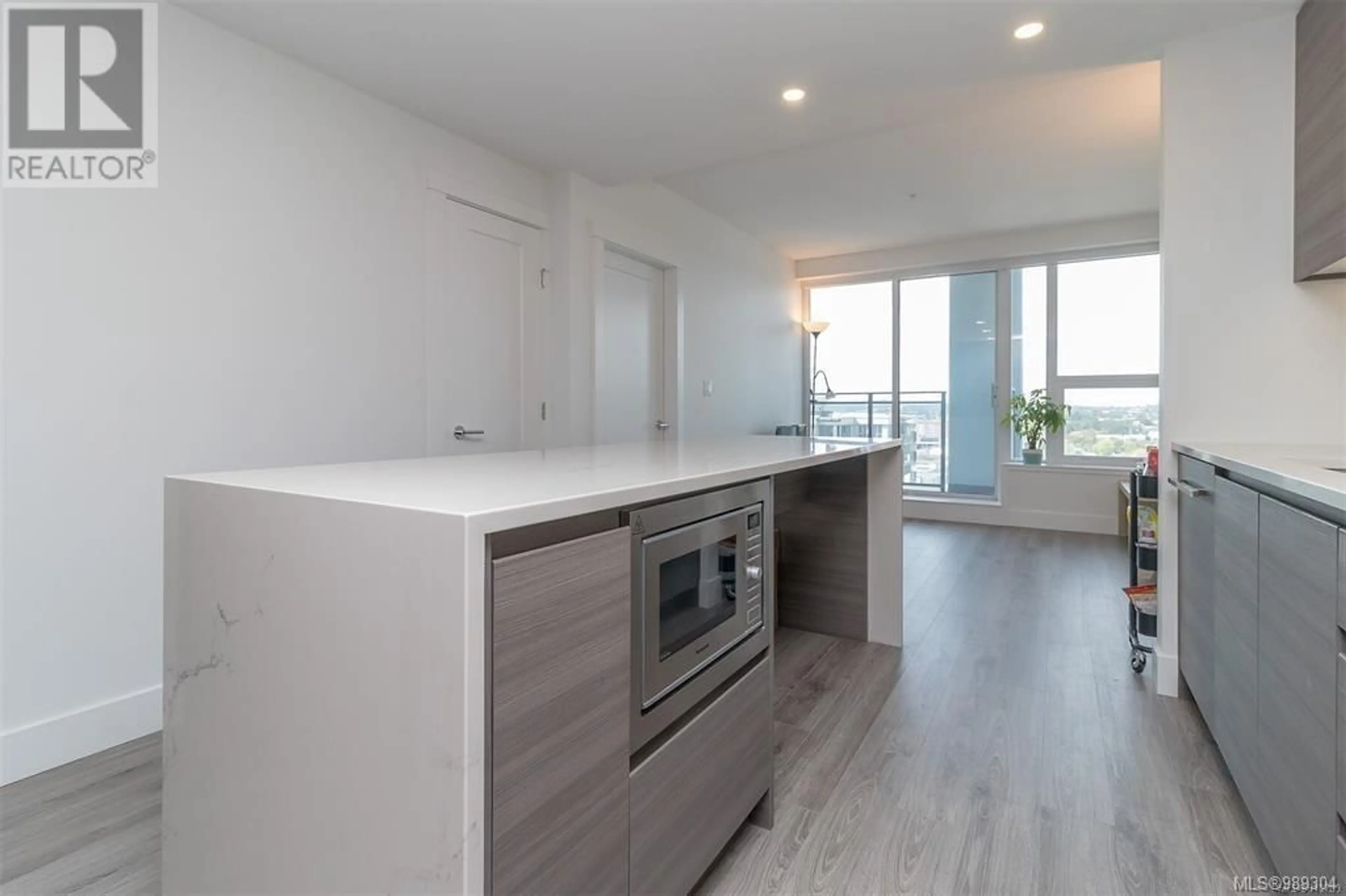 Open concept kitchen, wood/laminate floor for 1504 777 Herald St, Victoria British Columbia V8T0C7