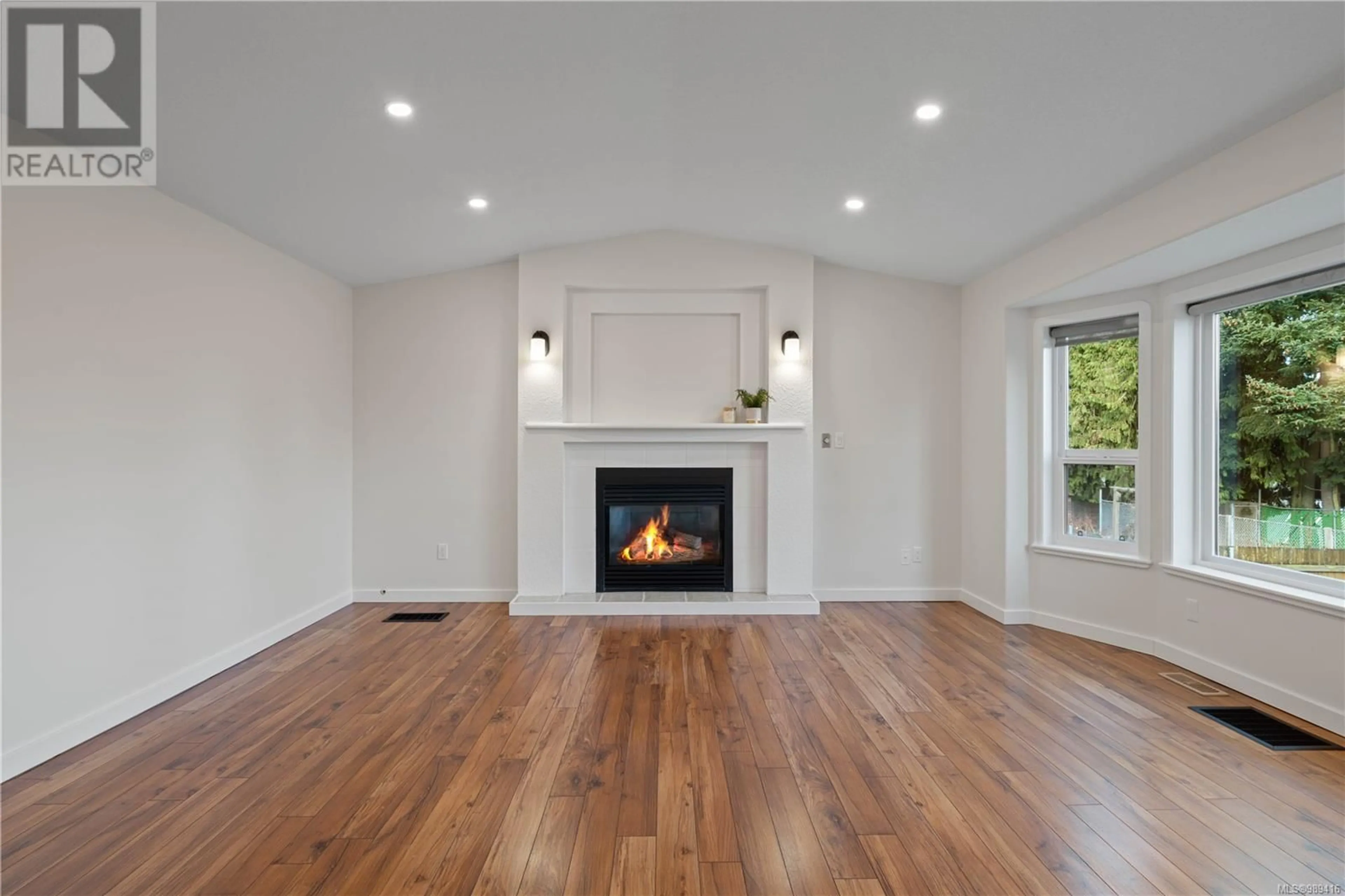 Living room with furniture, wood/laminate floor for 7412 Slogar Dr, Lantzville British Columbia V0R2H0