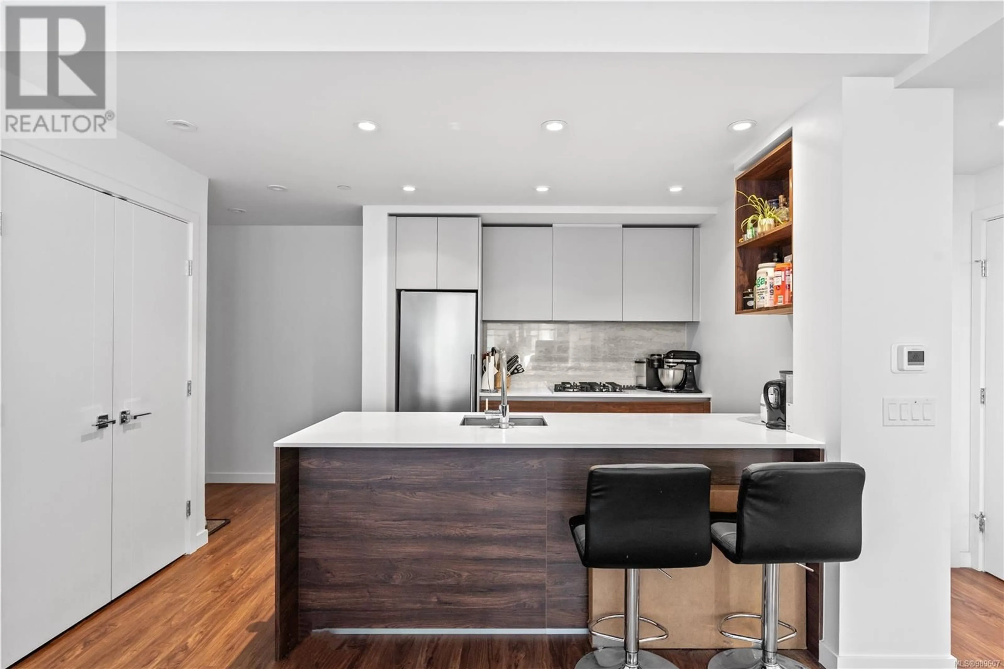 Contemporary kitchen, wood/laminate floor for 504 369 Tyee Rd, Victoria British Columbia V9A0B6