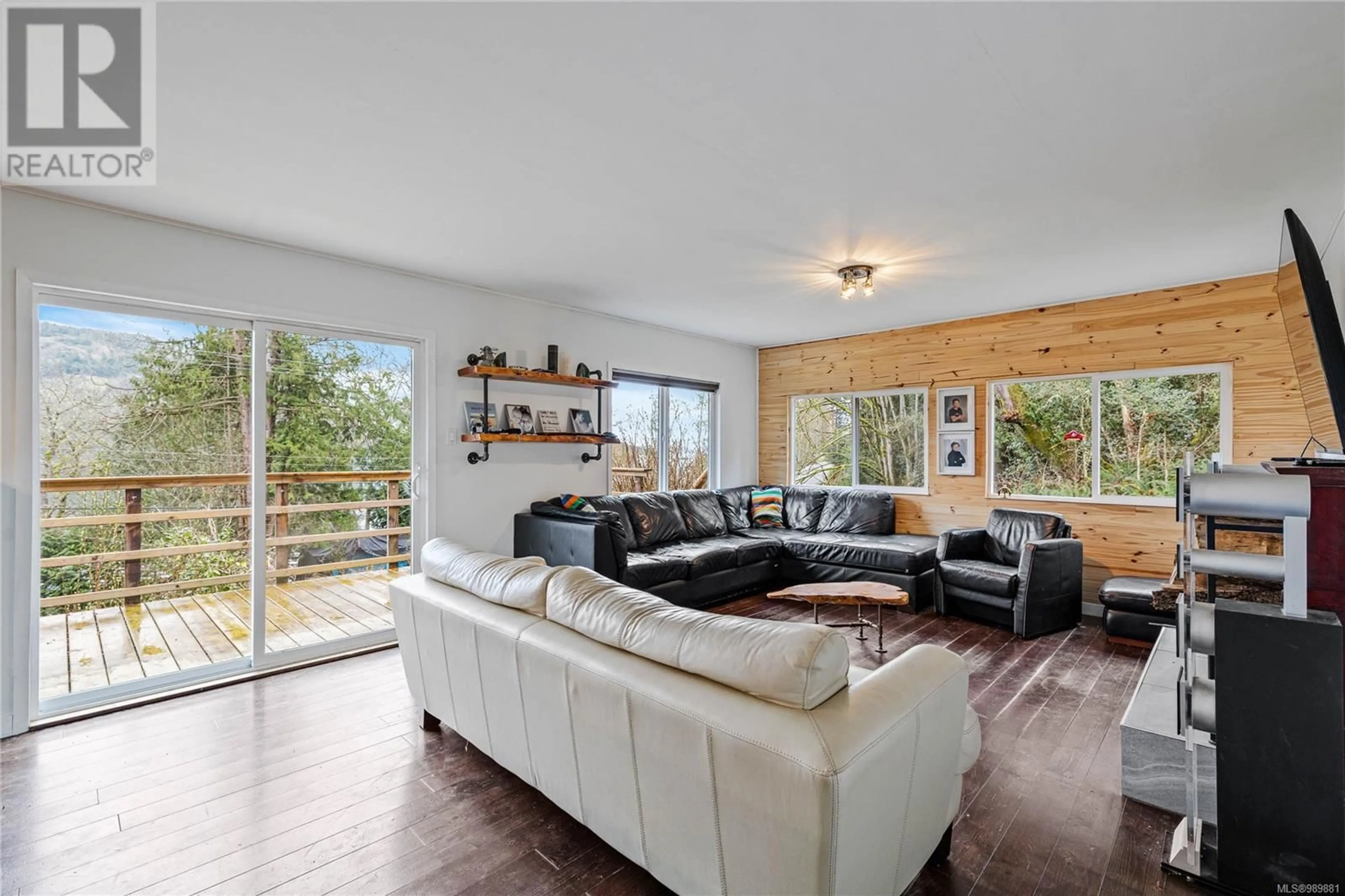 Living room with furniture, wood/laminate floor for 530 Isabella Point Rd, Salt Spring British Columbia V8K1V3