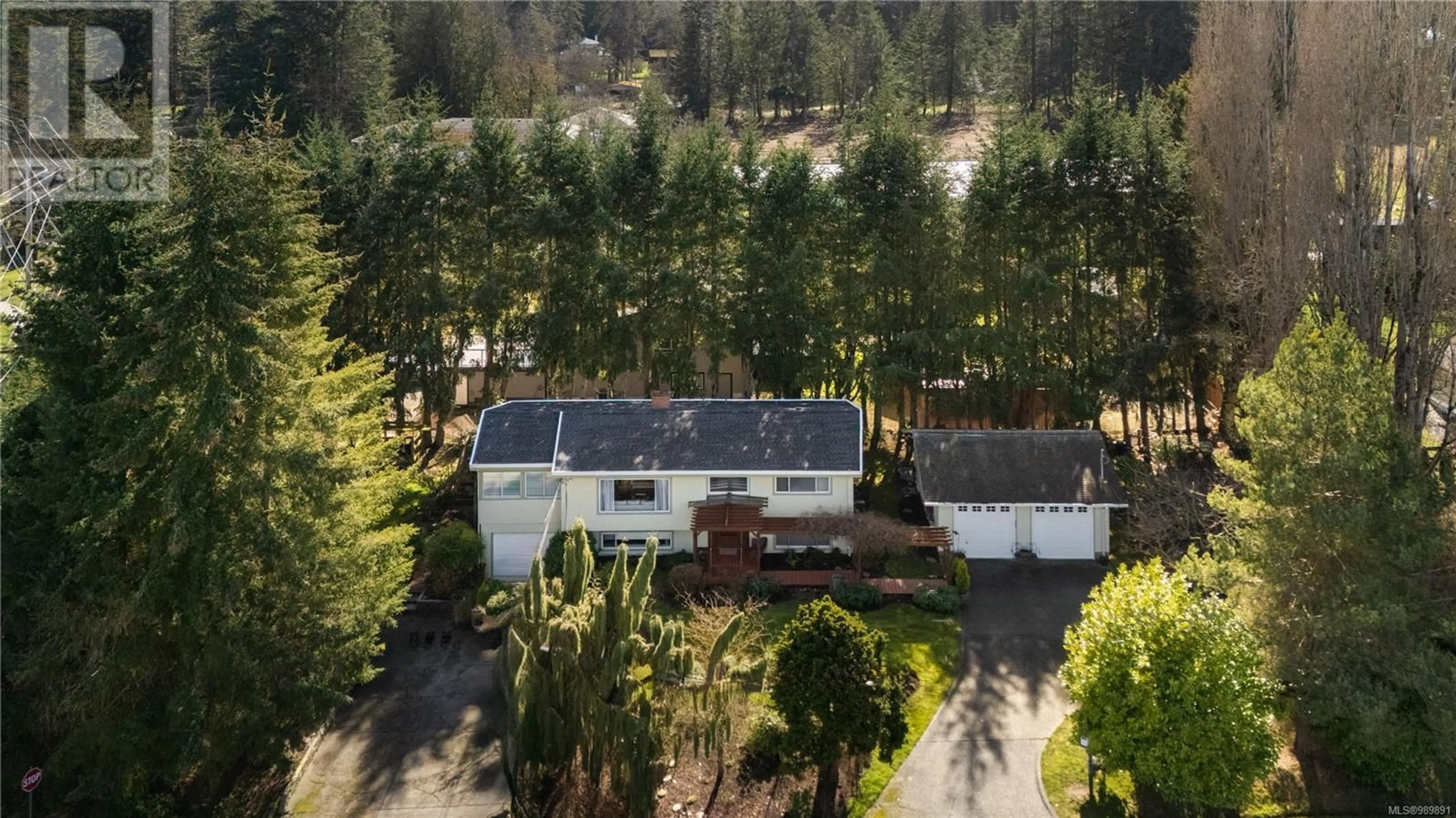 A pic from outside/outdoor area/front of a property/back of a property/a pic from drone, forest/trees view for 1925 Hovey Rd, Central Saanich British Columbia V8M1V8