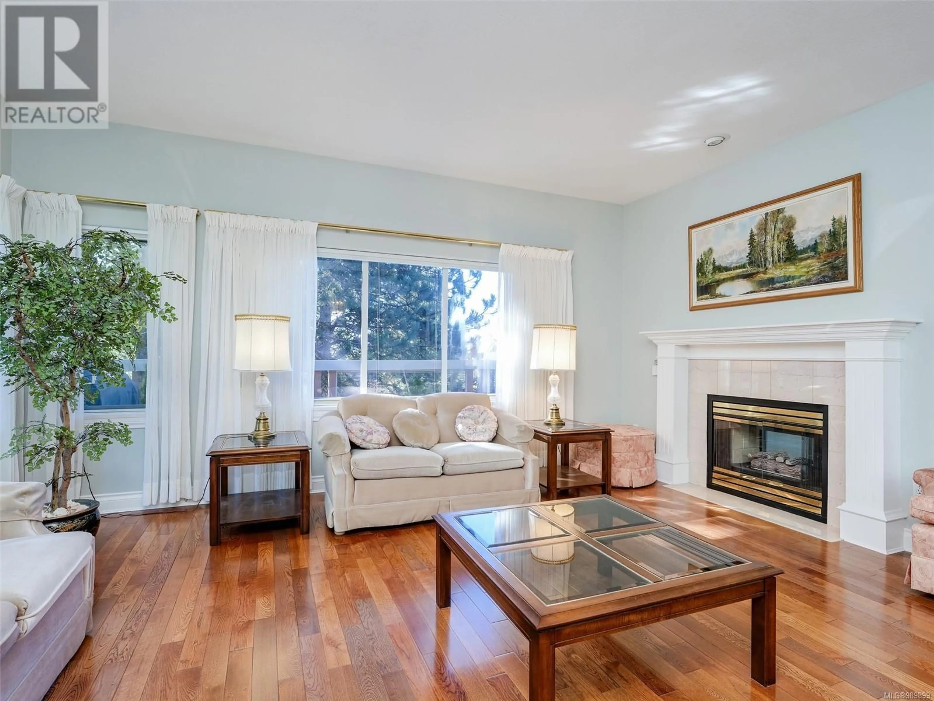 Living room with furniture, wood/laminate floor for 43 530 Marsett Pl, Saanich British Columbia V8Z7J2