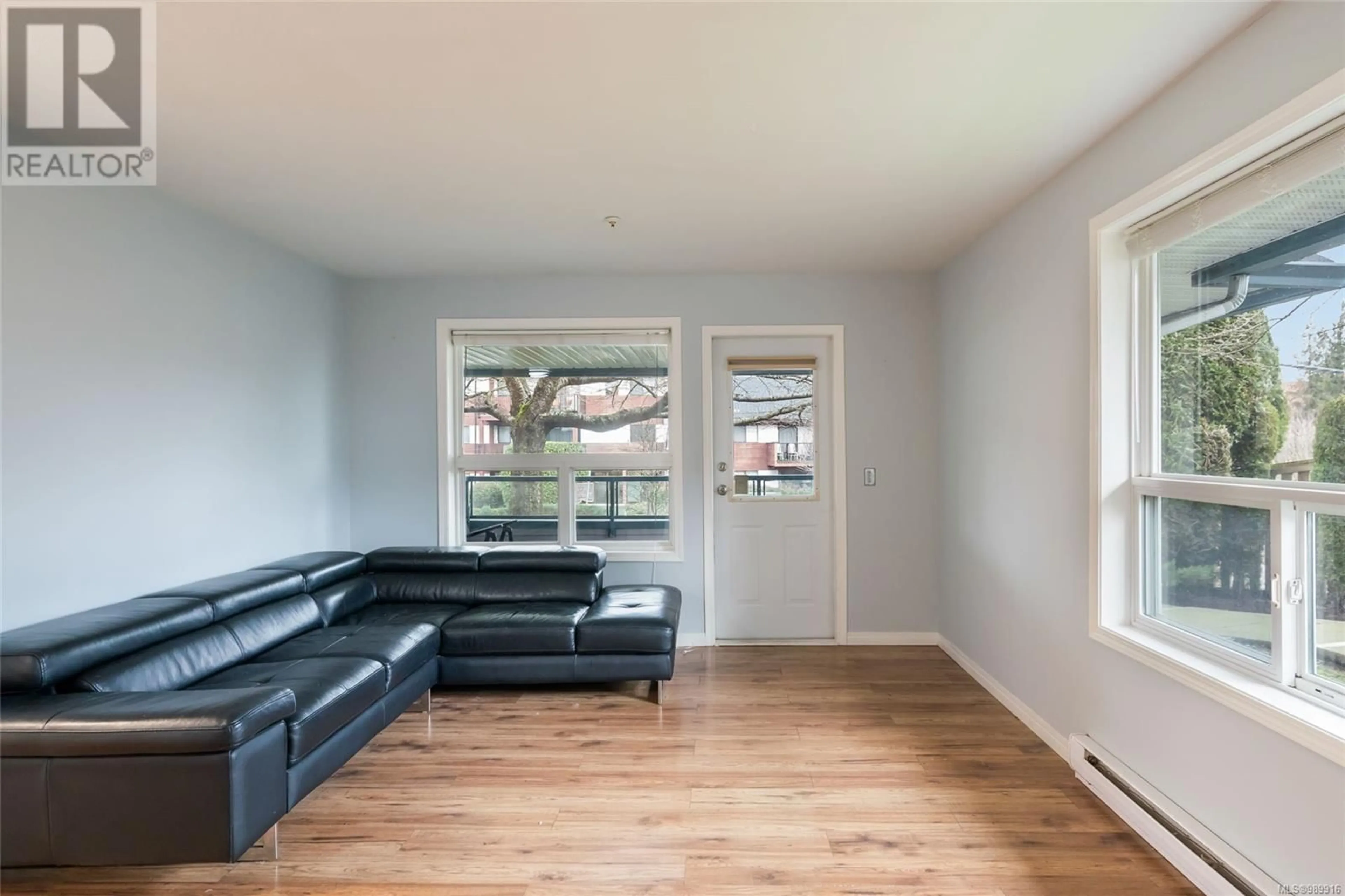 Living room with furniture, wood/laminate floor for 102 1631 Dufferin Cres, Nanaimo British Columbia V9S5T4