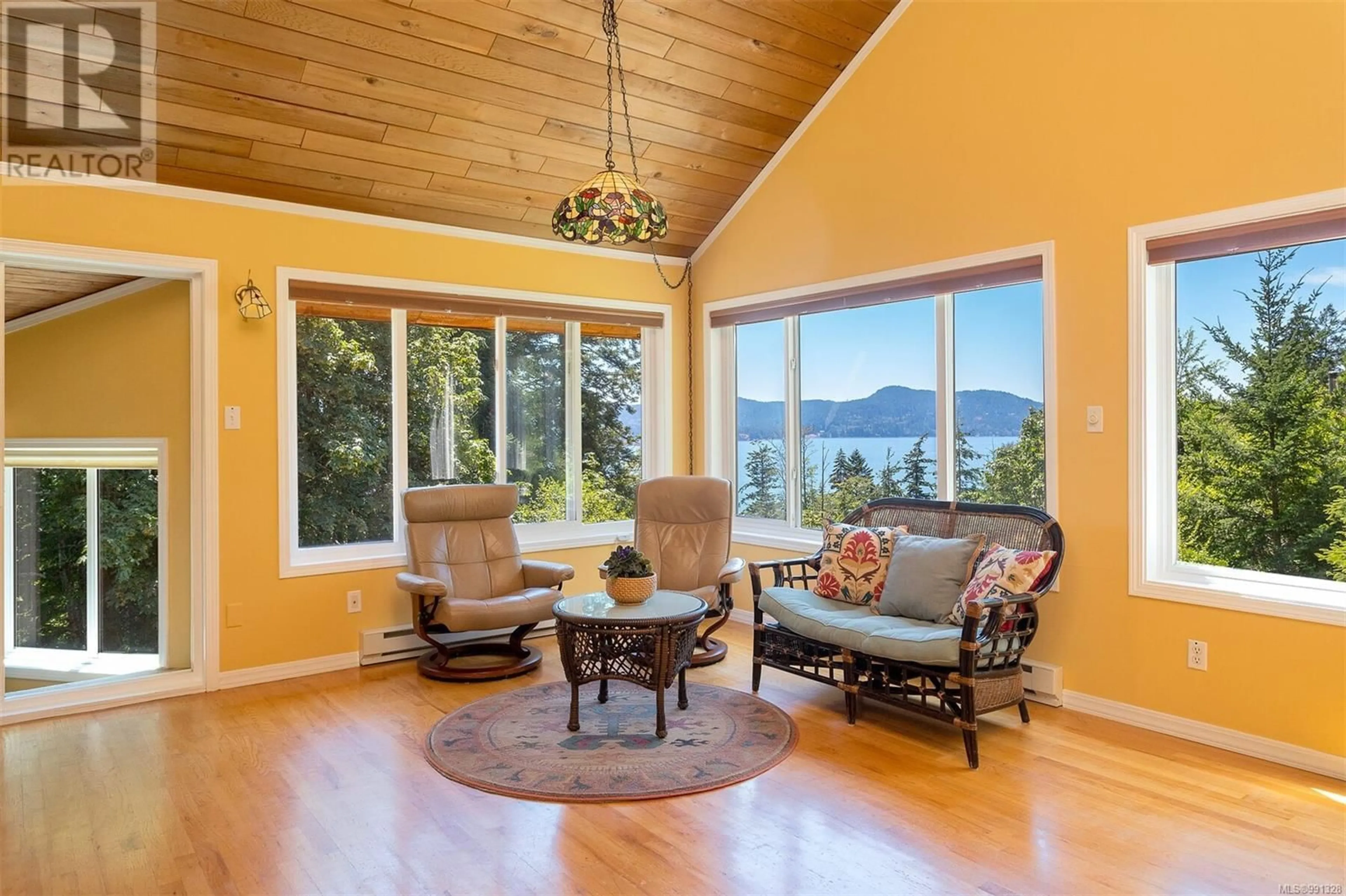 Living room with furniture, wood/laminate floor for 3013 Manzer Rd, Sooke British Columbia V9Z0C9