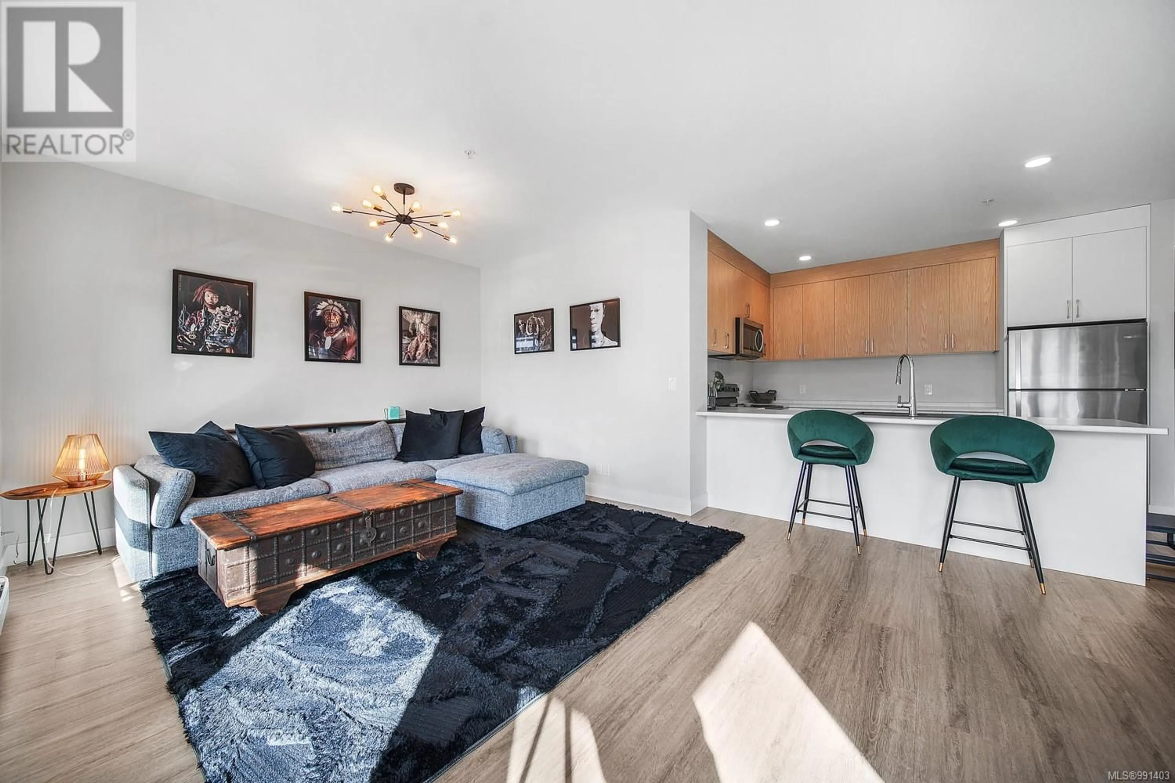 Living room with furniture, wood/laminate floor for 301 6544 Metral Dr, Nanaimo British Columbia V9T2L8