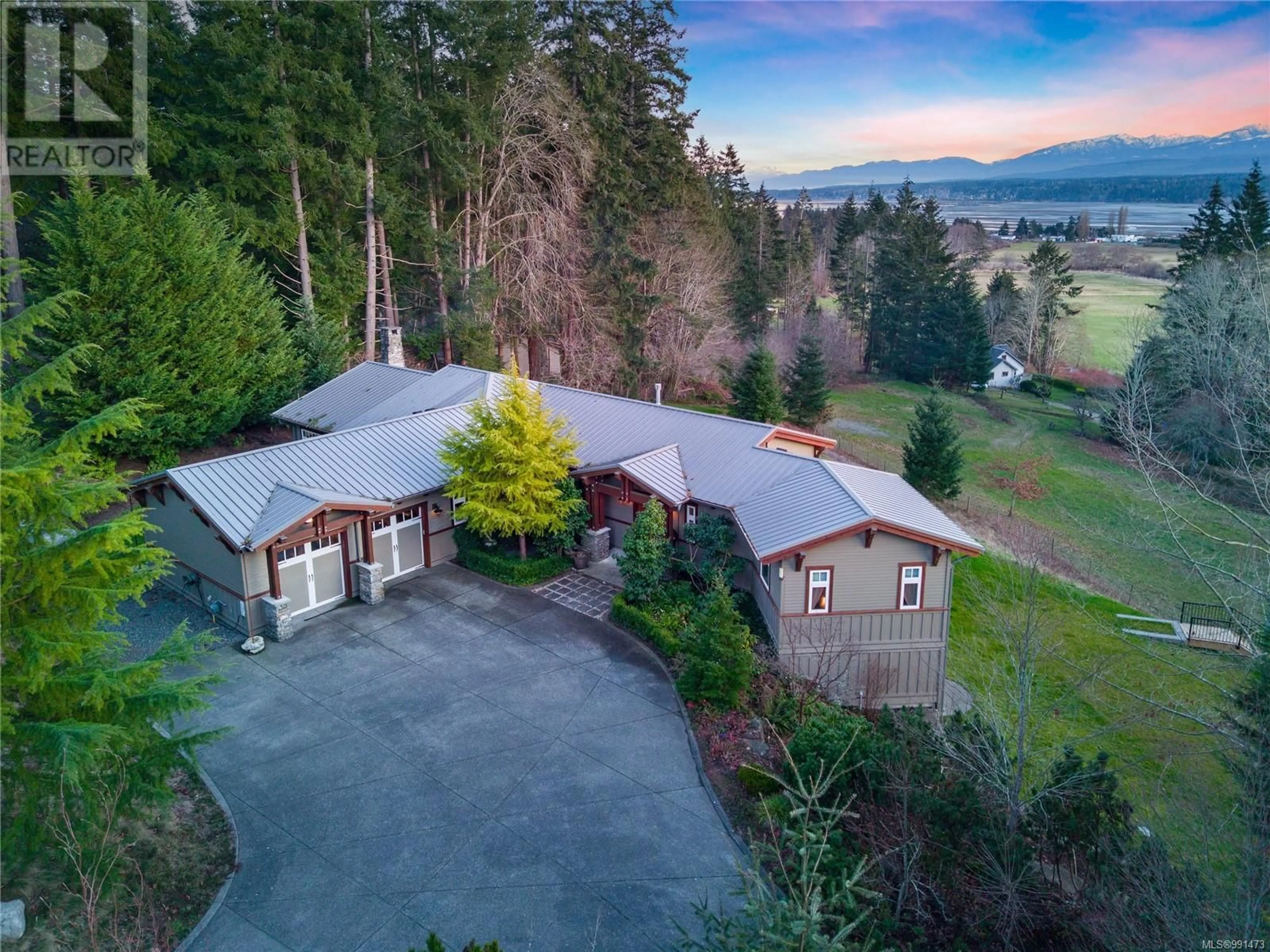 A pic from outside/outdoor area/front of a property/back of a property/a pic from drone, mountain view for 2465 Back Rd, Courtenay British Columbia V9N9G8