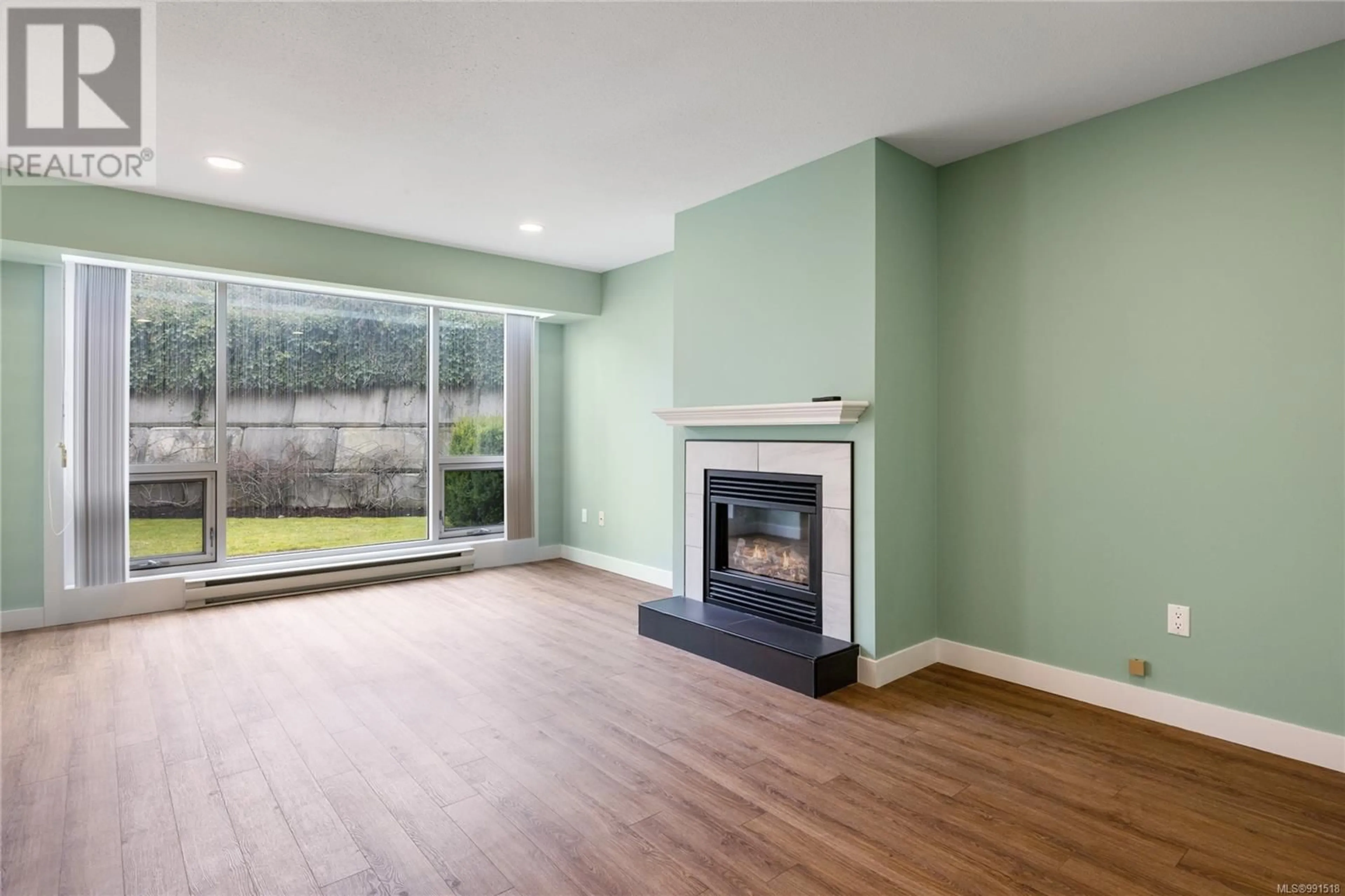 Living room with furniture, wood/laminate floor for 6006 Jake's Pl, Nanaimo British Columbia V9T6E7