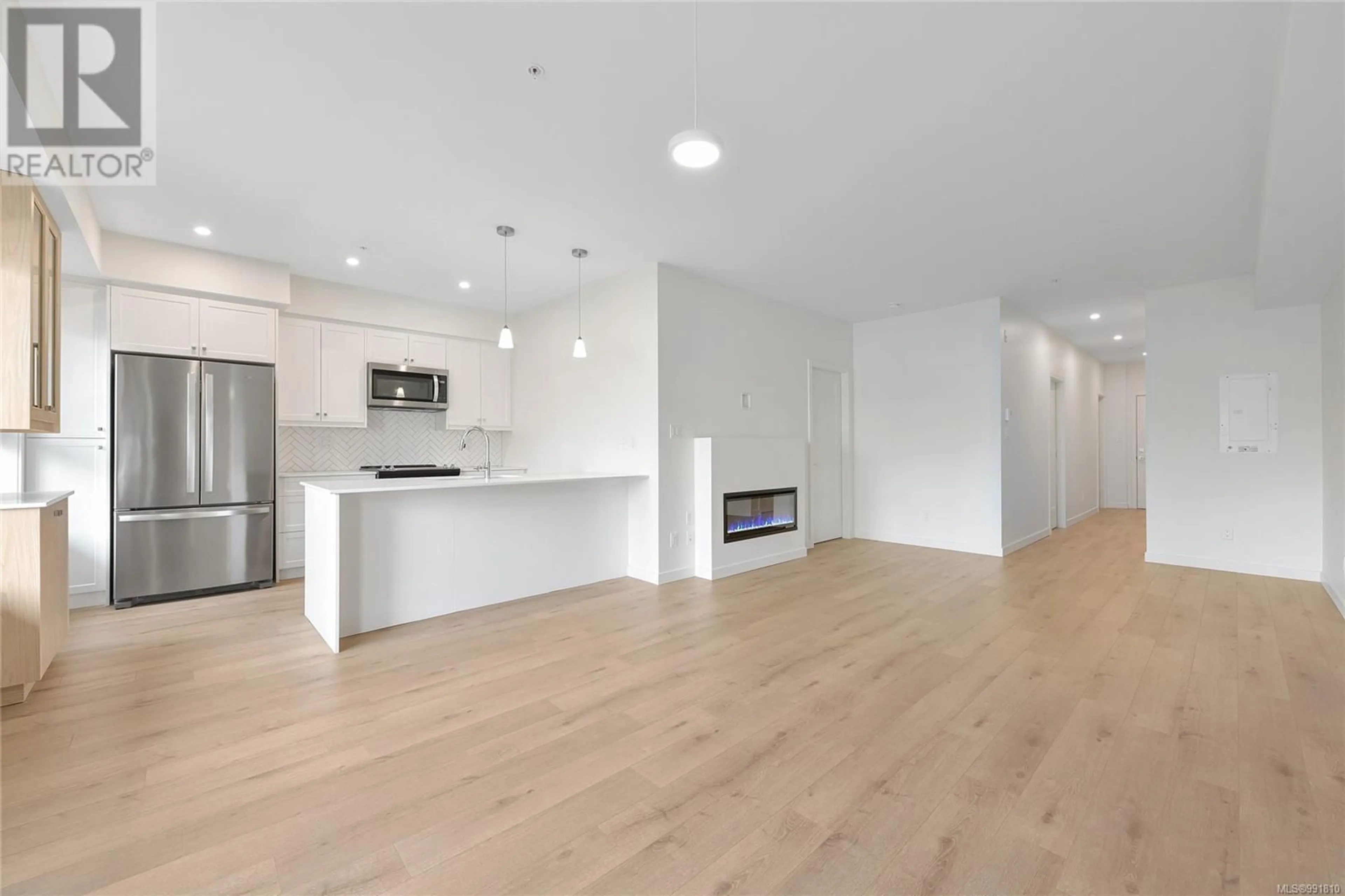 Open concept kitchen, wood/laminate floor for 203 - 9716 THIRD STREET, Sidney British Columbia V8L3A2