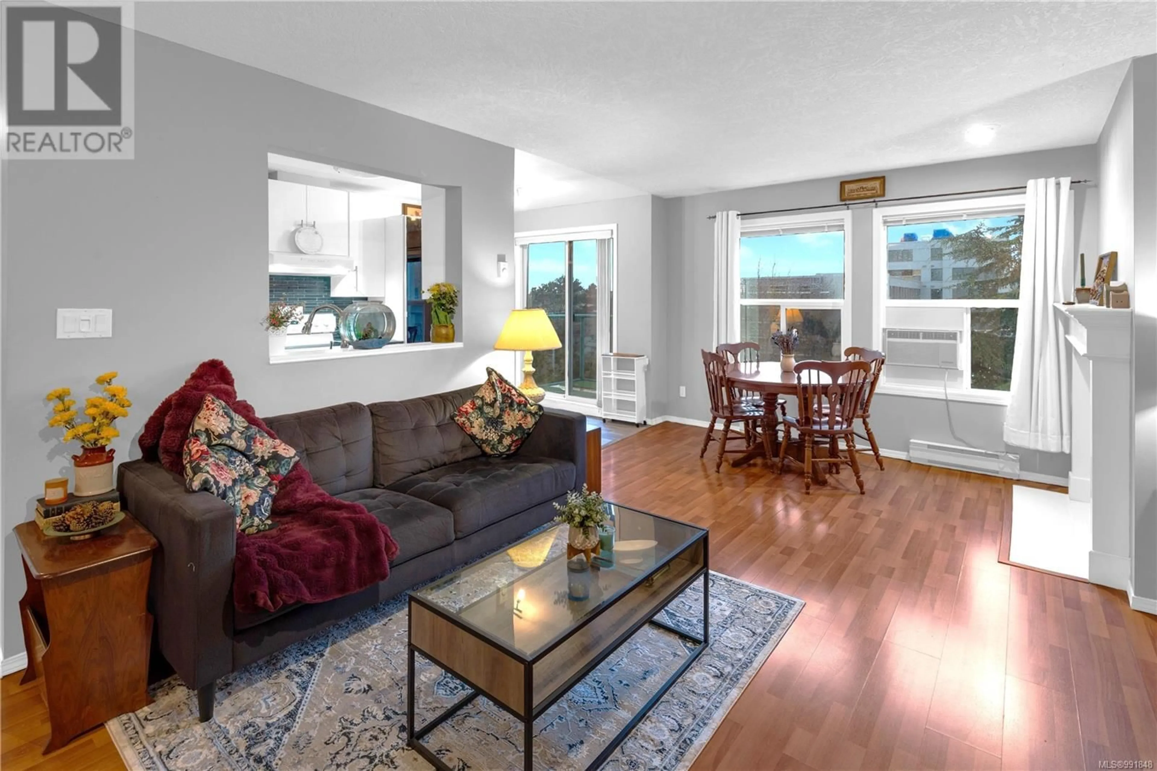 Living room with furniture, wood/laminate floor for 402 - 894 VERNON AVENUE, Saanich British Columbia V8X2W6