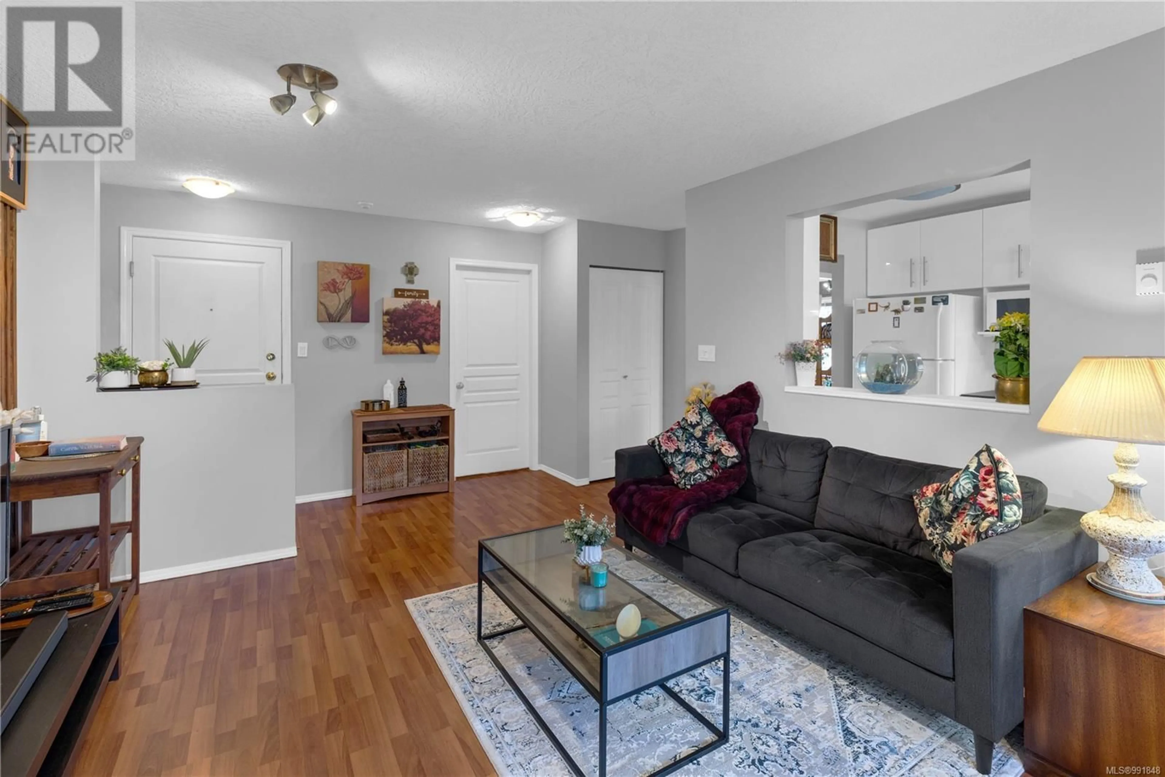 Living room with furniture, wood/laminate floor for 402 - 894 VERNON AVENUE, Saanich British Columbia V8X2W6