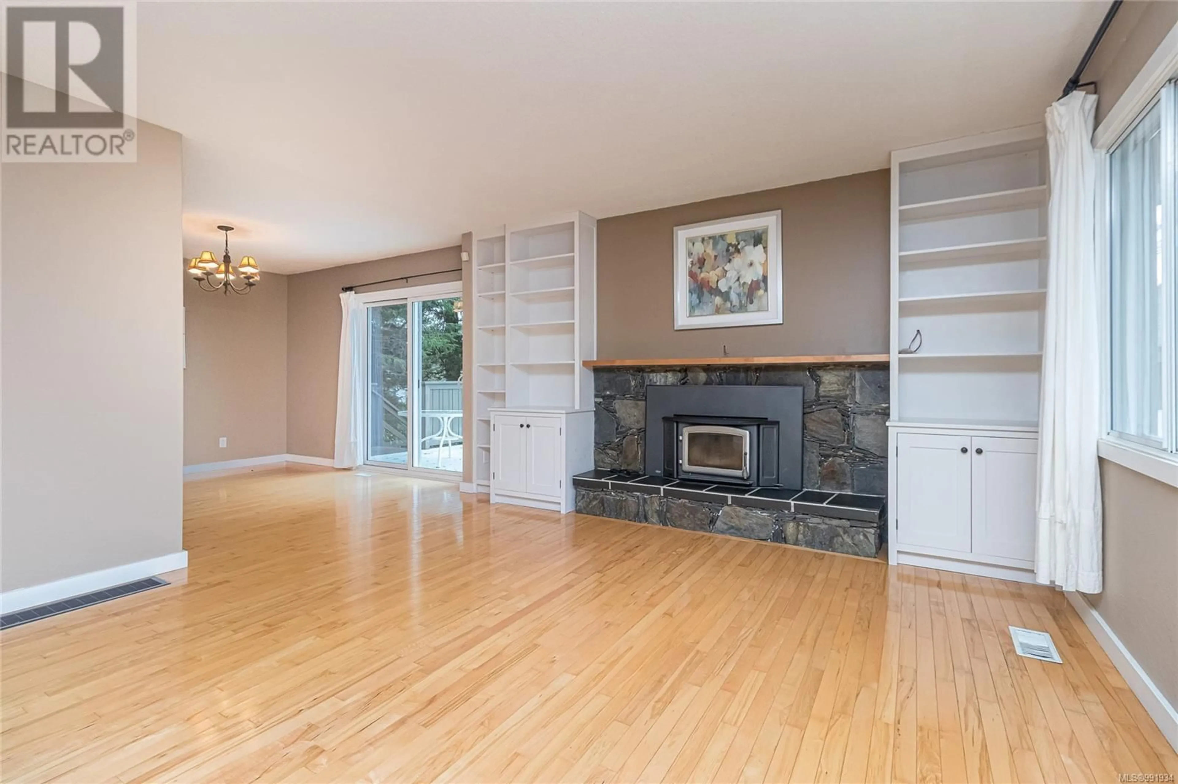 Living room with furniture, wood/laminate floor for 1667 Bisley Pl, Saanich British Columbia V8N4M6