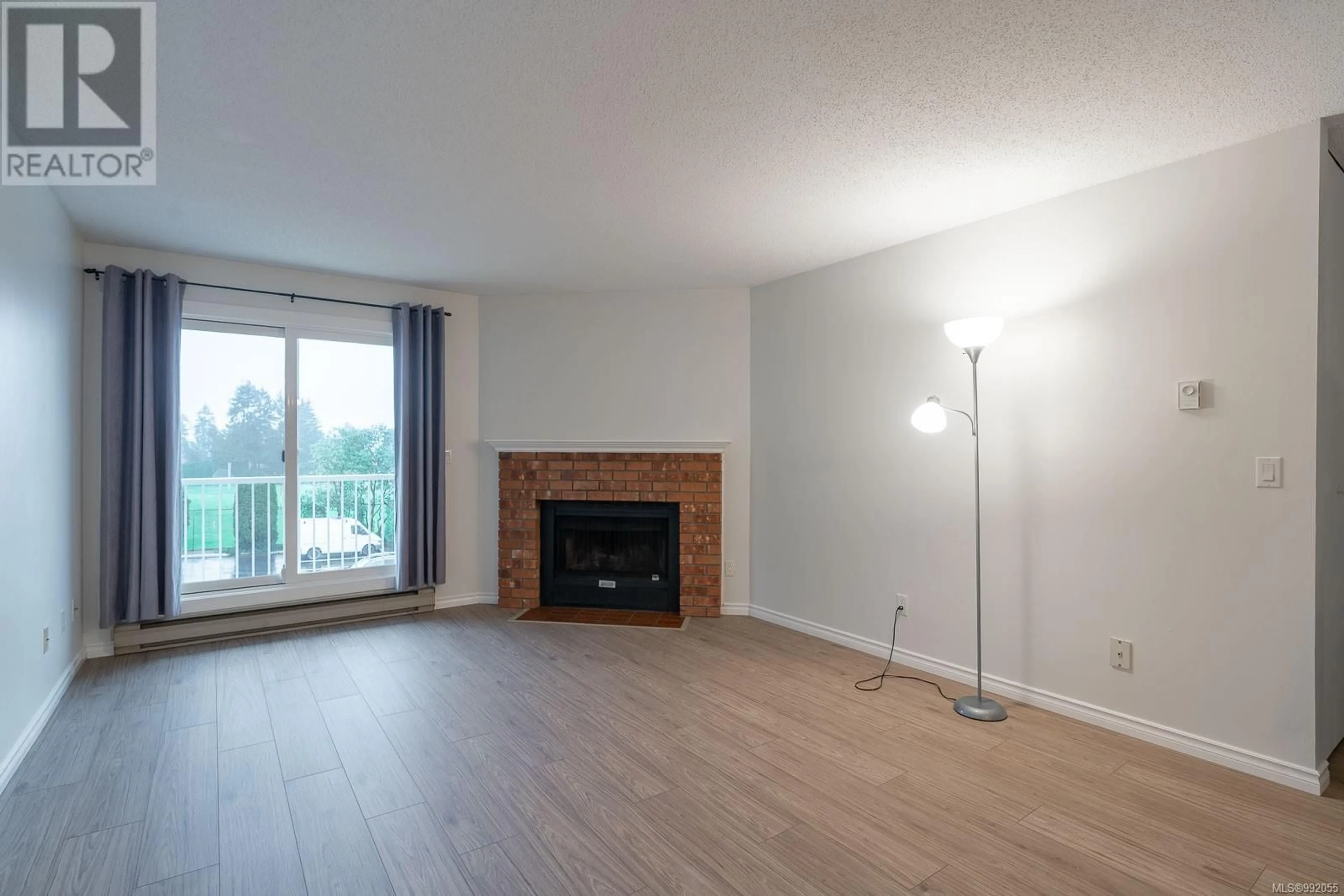 Living room with furniture, wood/laminate floor for 415 3270 Ross Rd, Nanaimo British Columbia V9T5J1