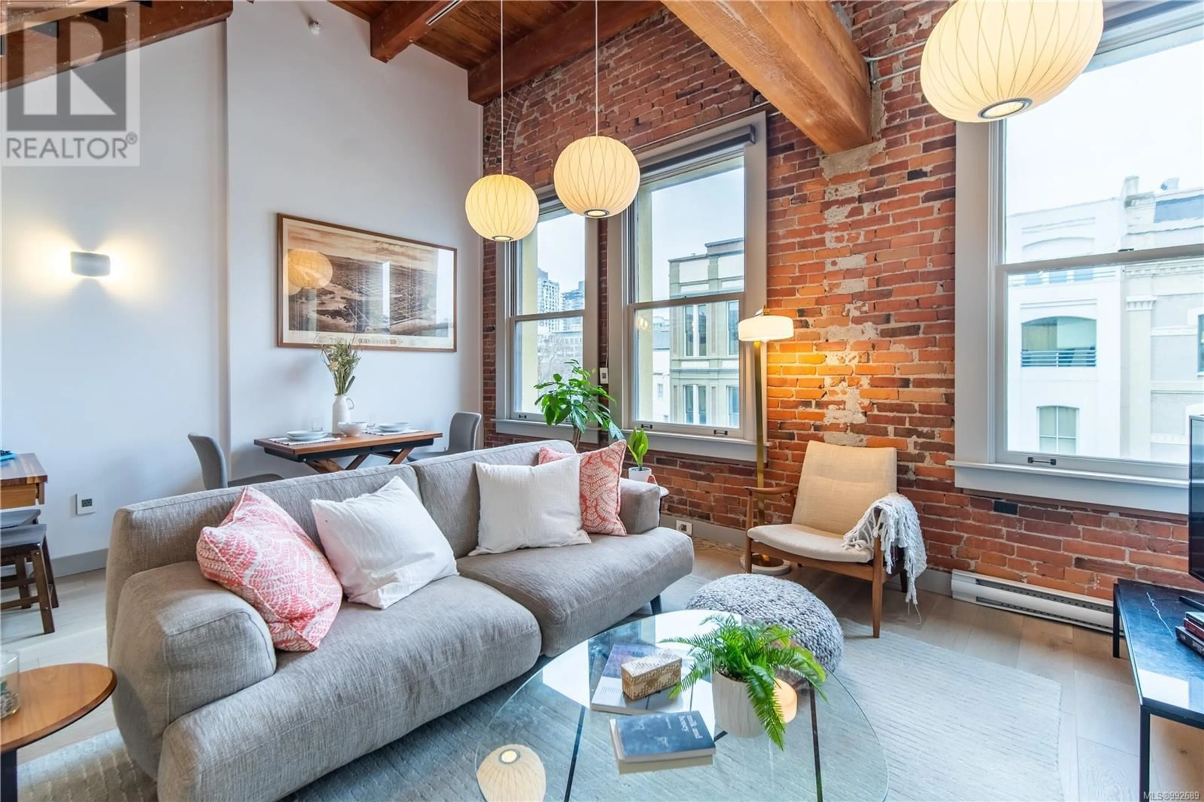 Living room with furniture, cement floor for 317 - 599 PANDORA AVENUE, Victoria British Columbia V8W1N5