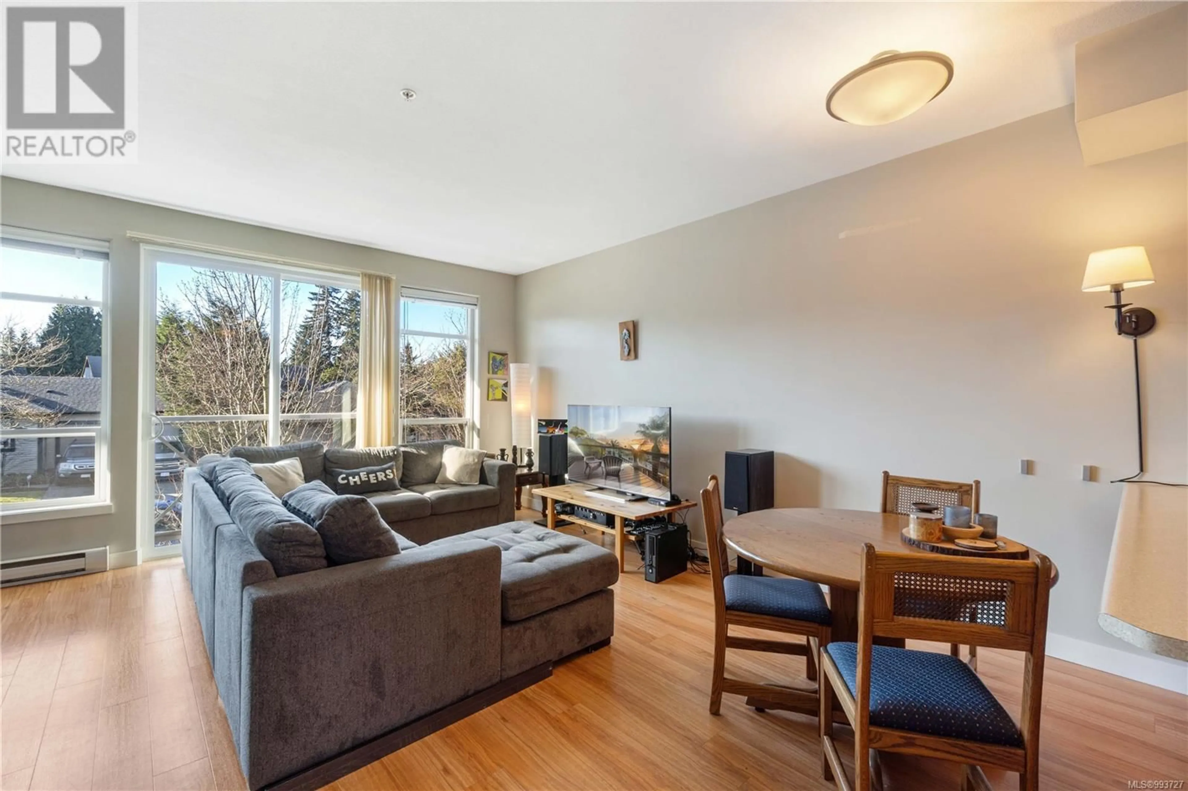 Living room with furniture, wood/laminate floor for 208 - 5170 DUNSTER ROAD, Nanaimo British Columbia V9T2Z2