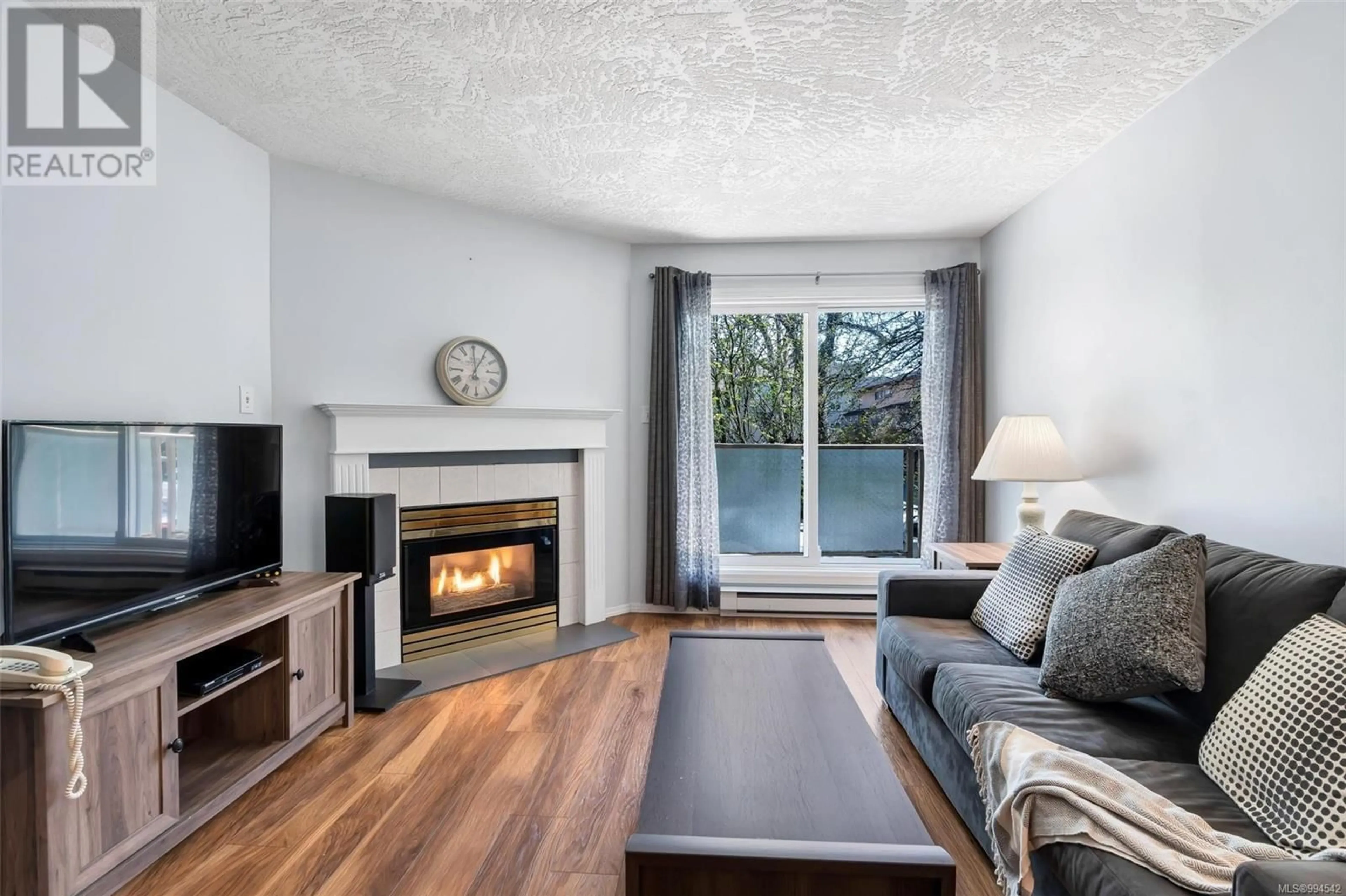 Living room with furniture, wood/laminate floor for 207 - 2710 GROSVENOR ROAD, Victoria British Columbia V8T3M9